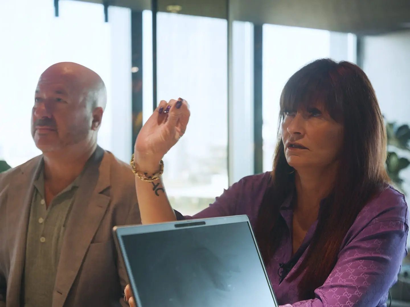 Rebecca Fowler and her husband telling a designer what customizations they want