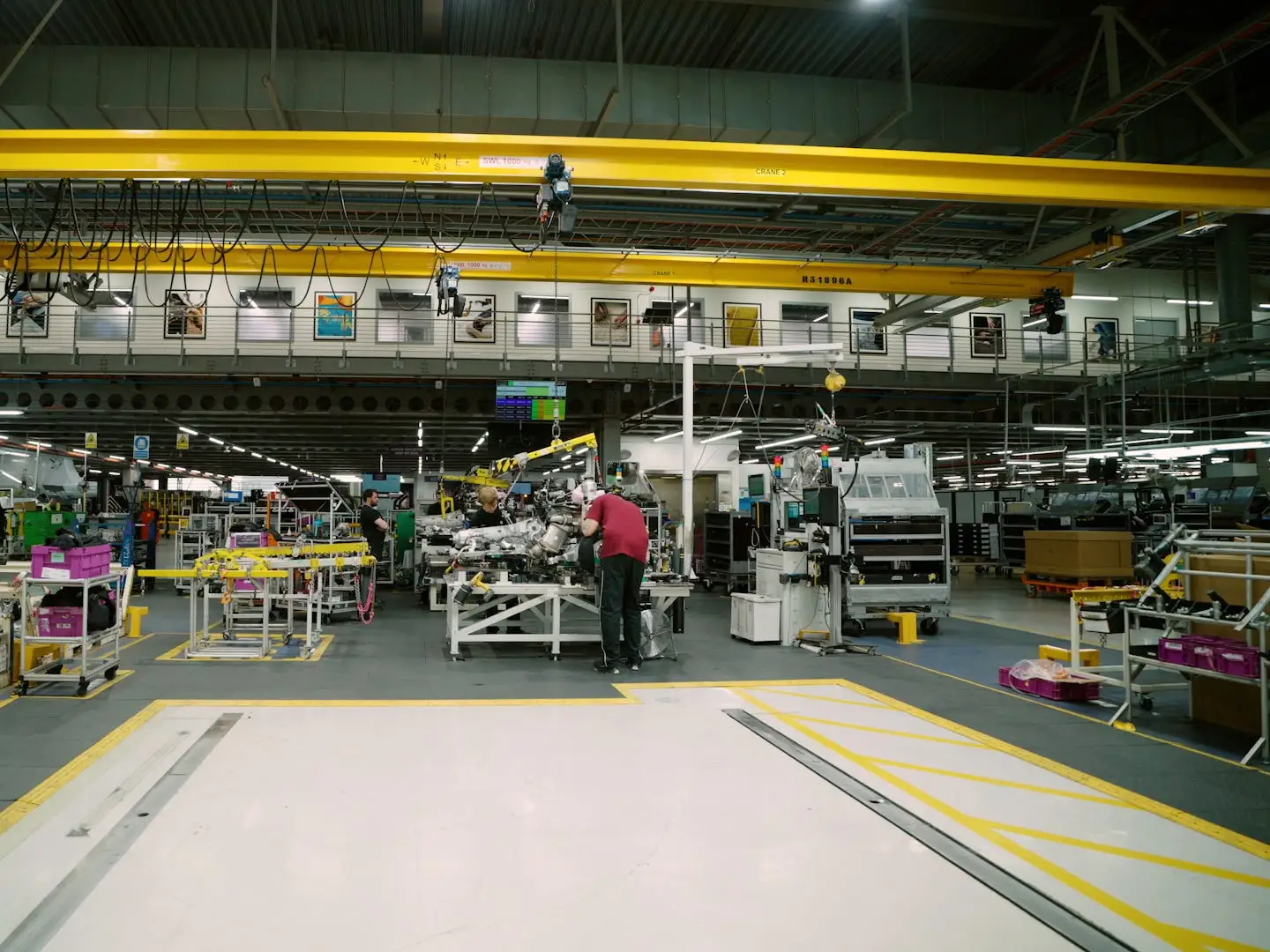 A worker hunched over a table in the distance in Rolls Royce's factory