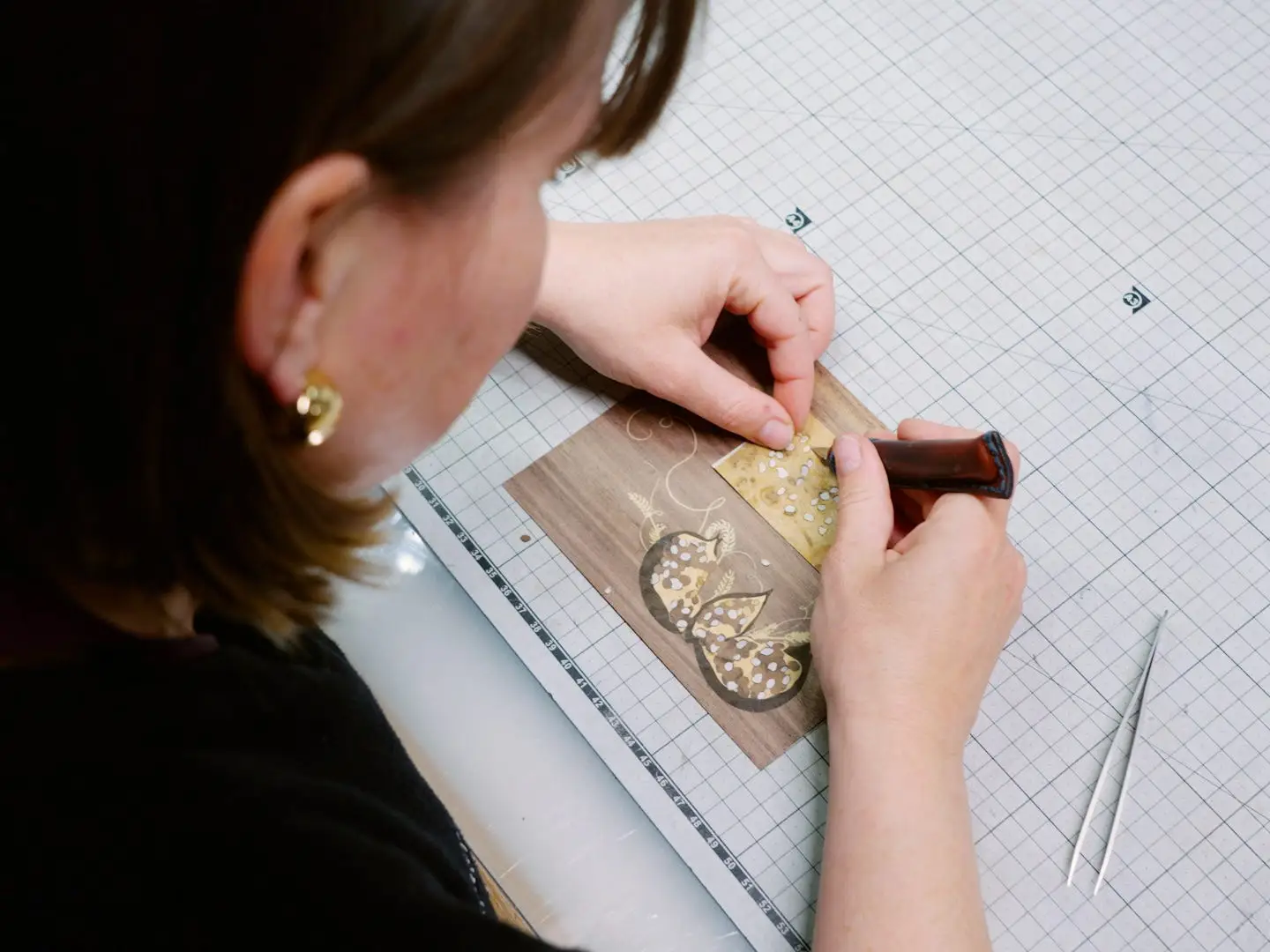 A worker crafts a wooden veneer
