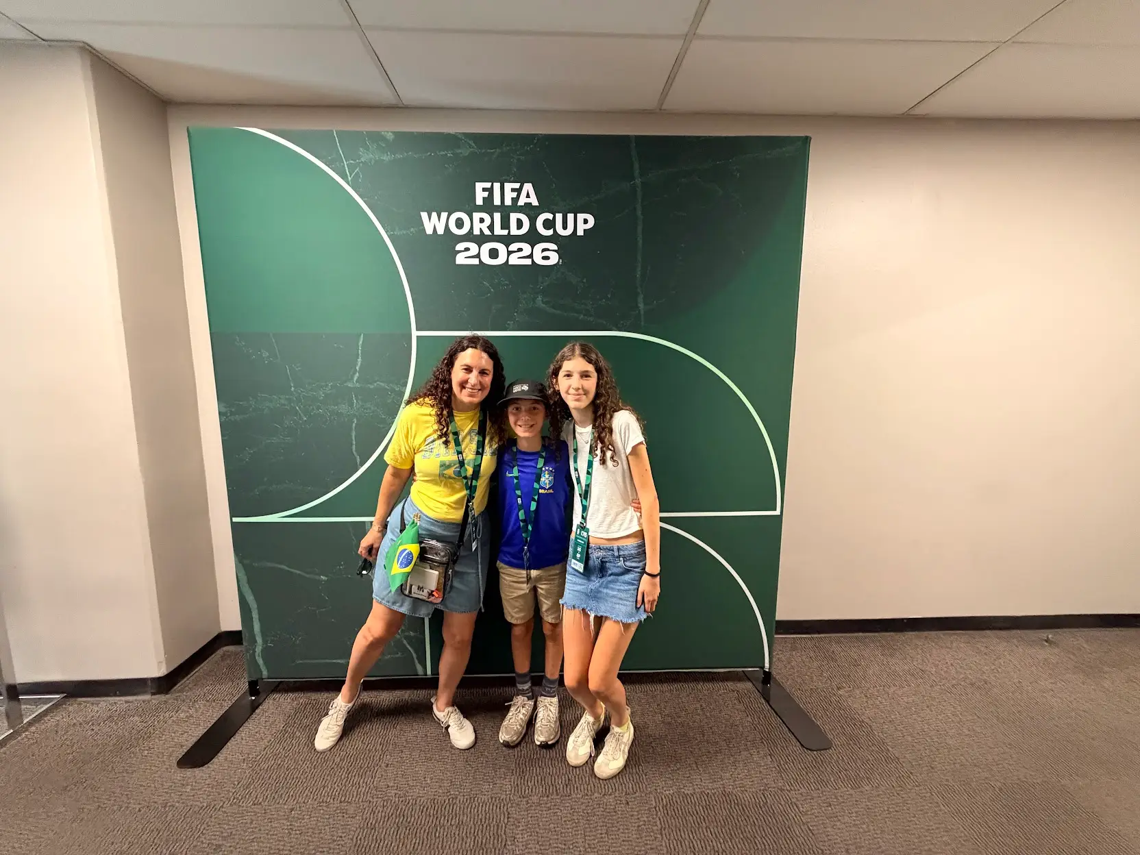 the author and her kids in front of a sign that says FIFA World Cup 2026