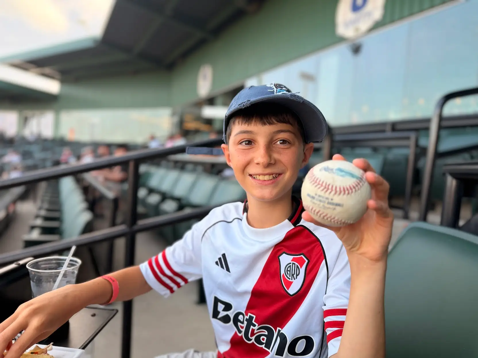 the author's son holding up a baseball