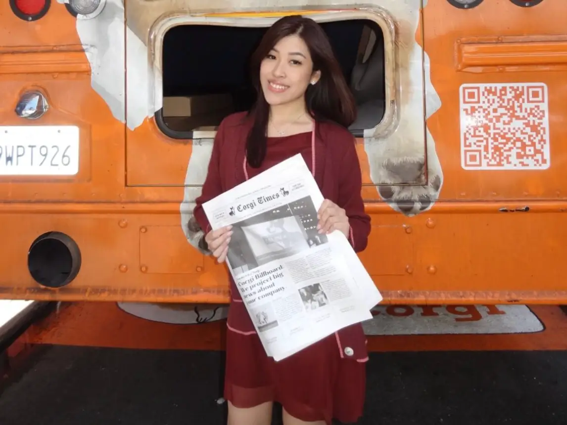 Erika Lee is holding a newspaper in her hand.