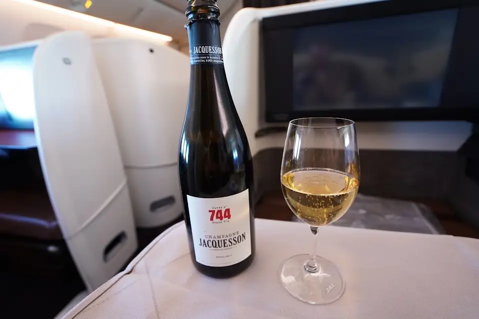 The Champagne Jacquesson 744 bottle next to the glass.