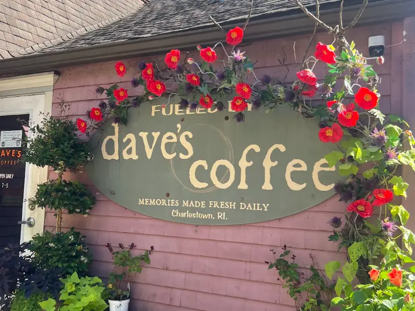 An exterior shot of Dave's Coffee café in Charlestown, Rhode Island, with flowers.