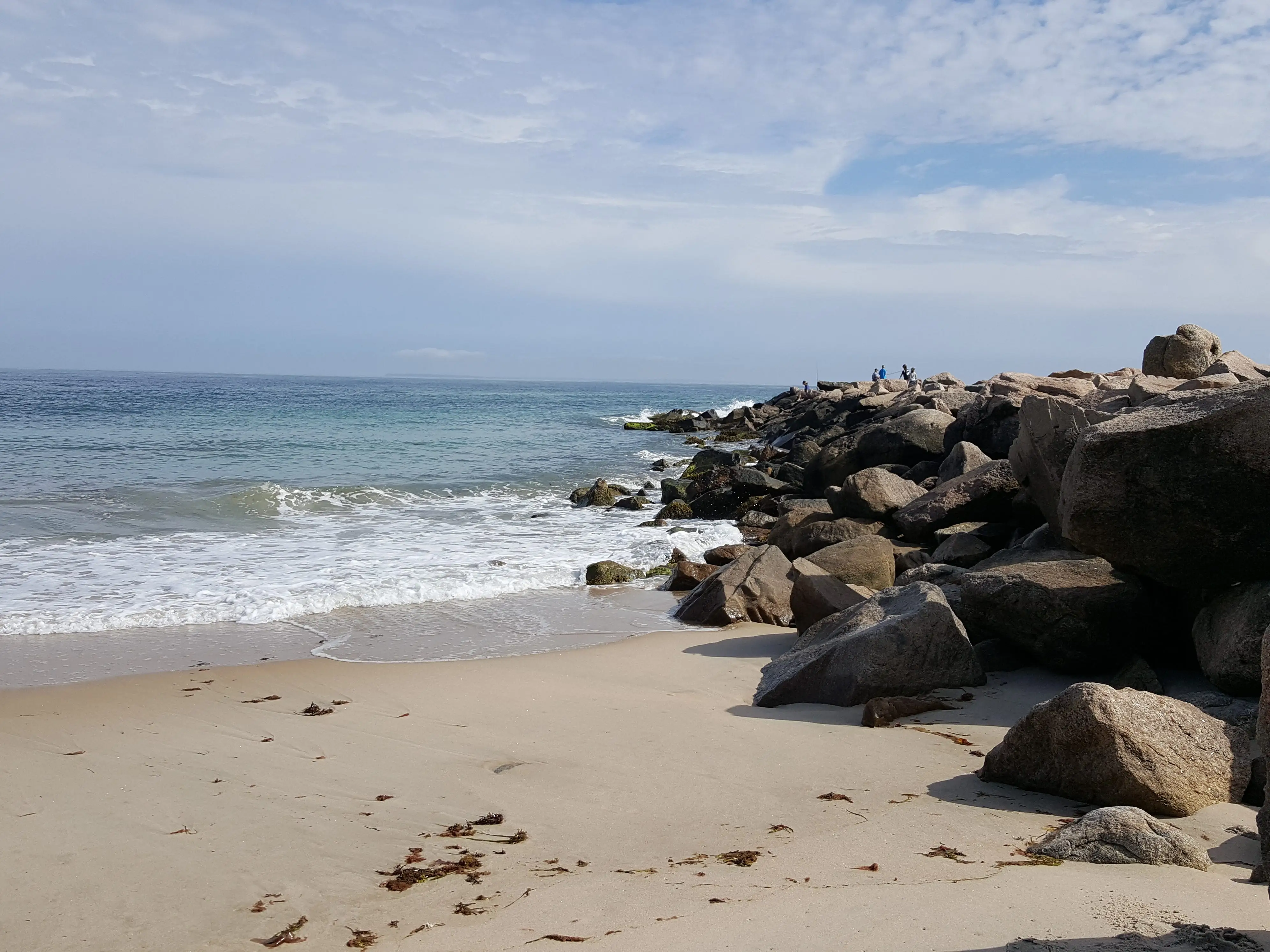 An empty beach with rocks in Charlestown, Rhode Island.