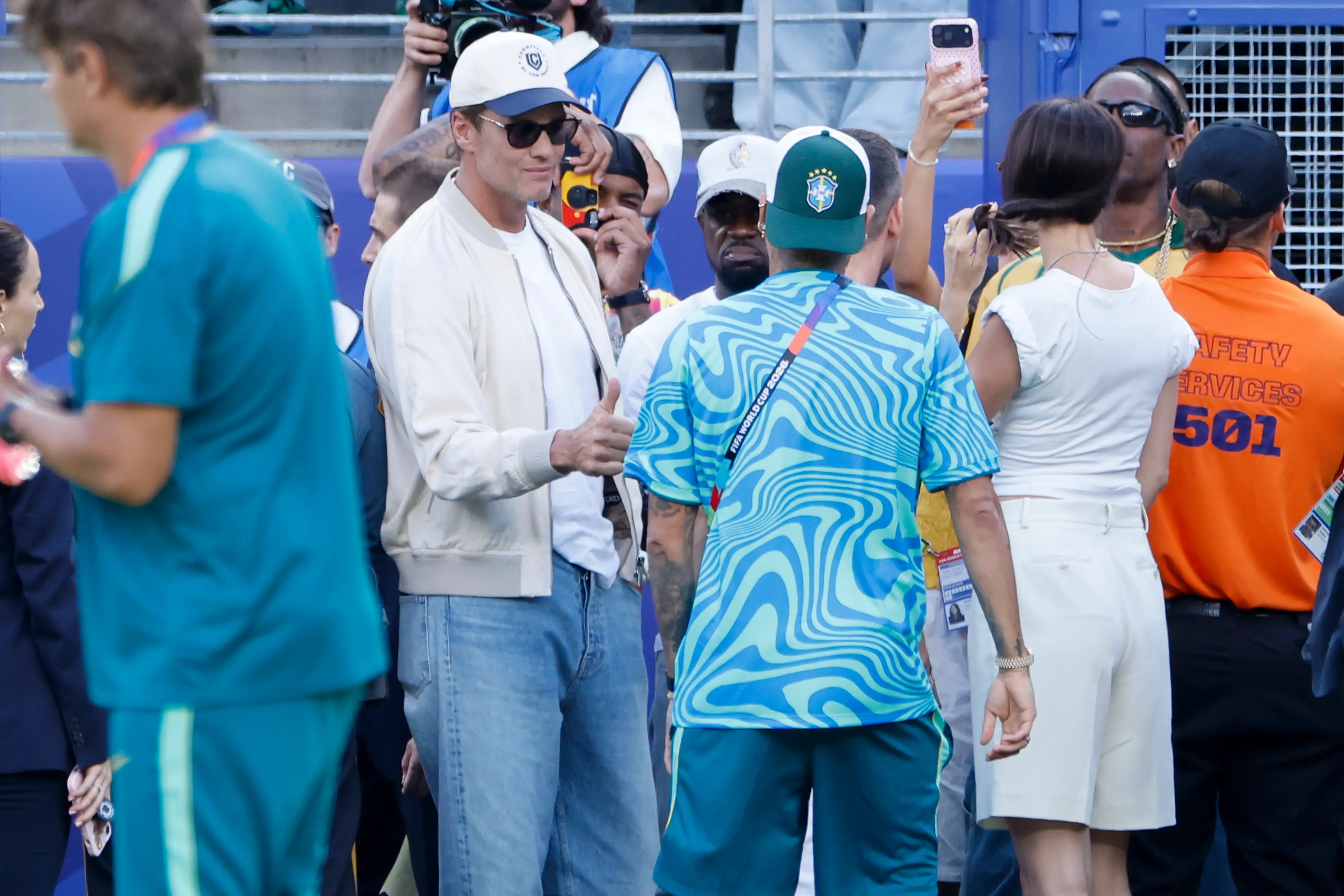 Tom Brady salutes Neymar Jr #10 of Brazil on the pitch before the FIFA World Cup 2026 Group C football match between Brazil and Morocco at New York New Jersey Stadium on June 13, 2026 in East Rutherford, United States.