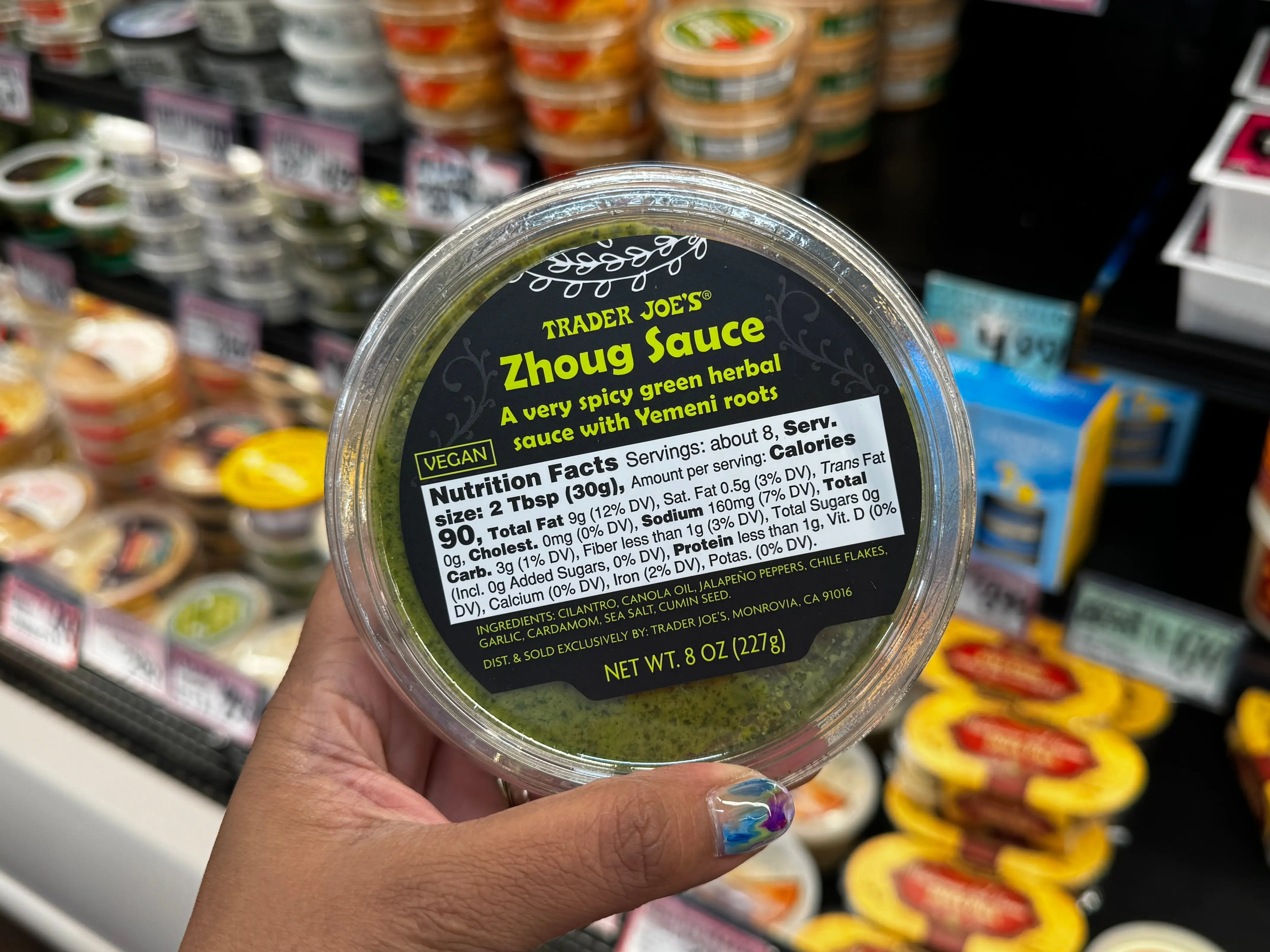 A container of Trader Joe's Zhoug sauce.