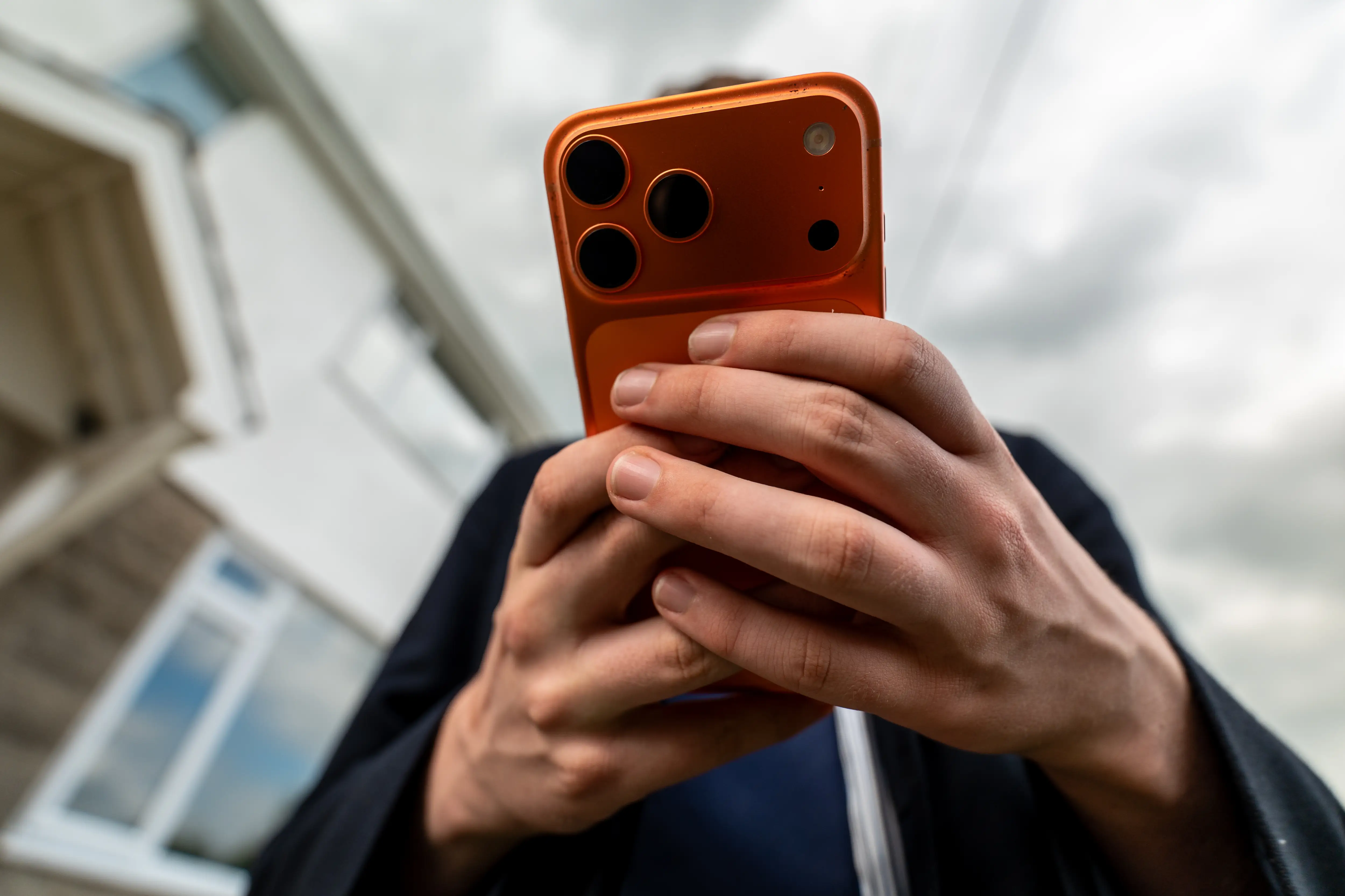 A man holds an iPhone