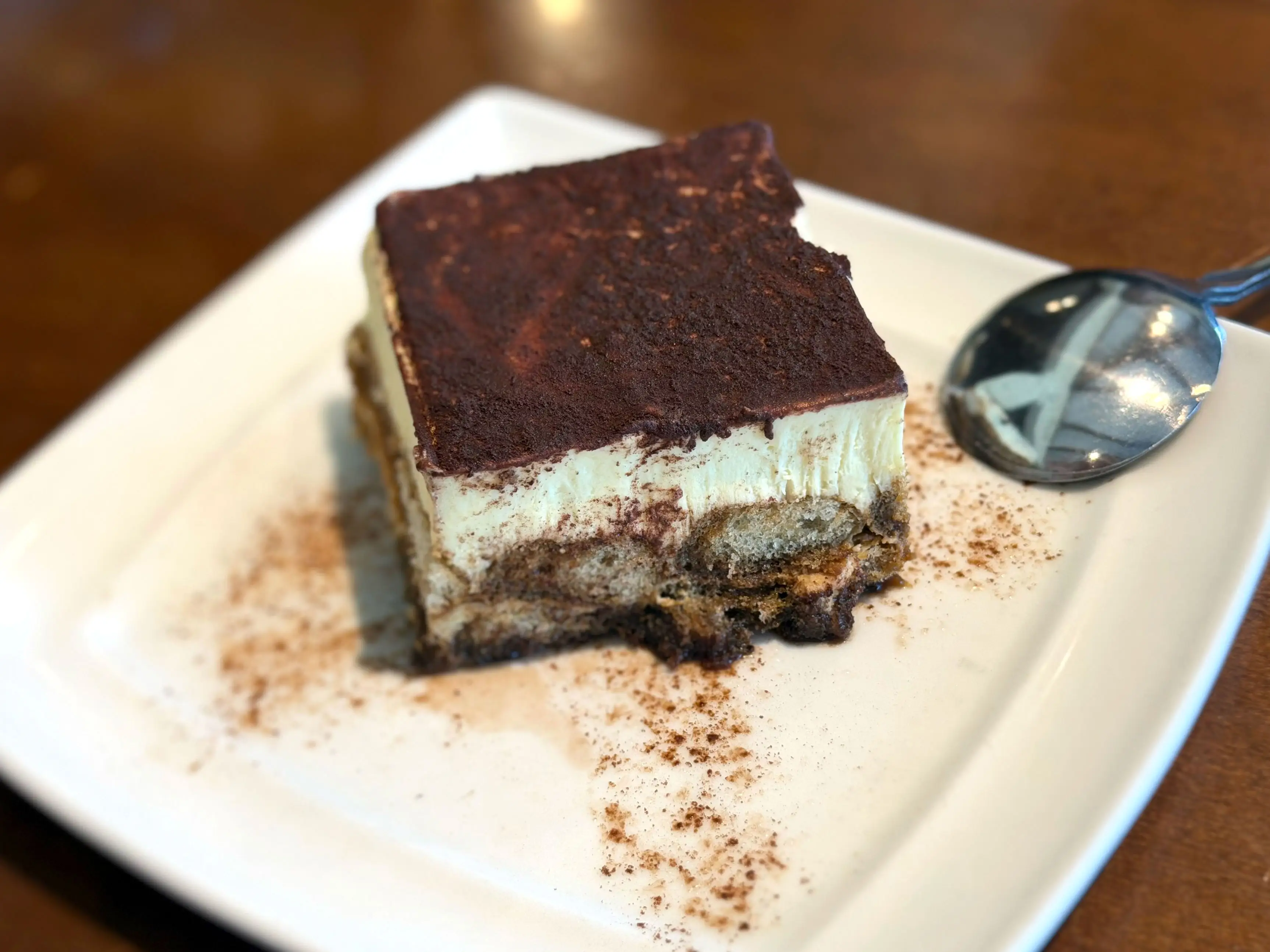 A piece of tiramisu on a plate.
