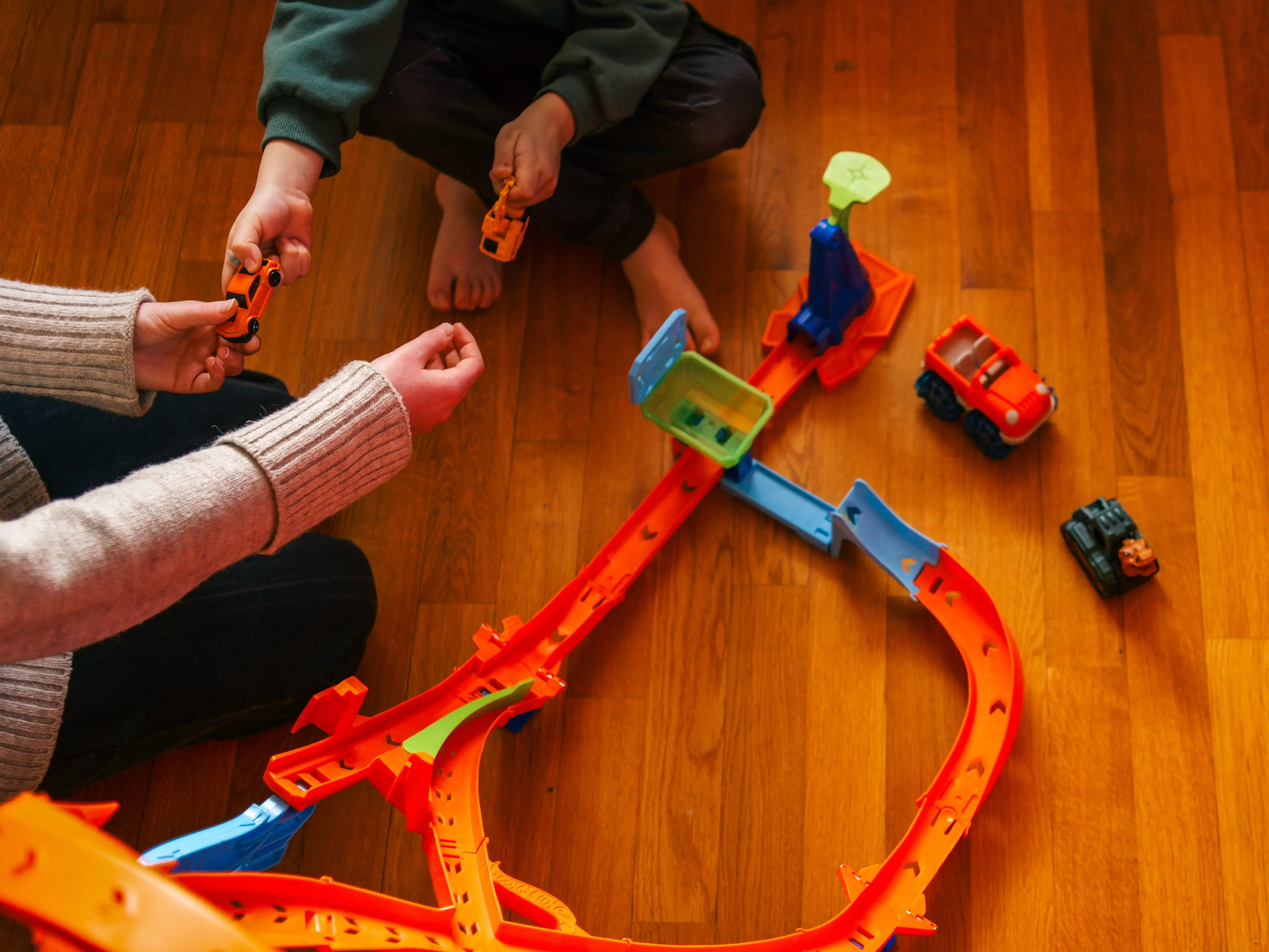 a woman playing with toys with a young boy