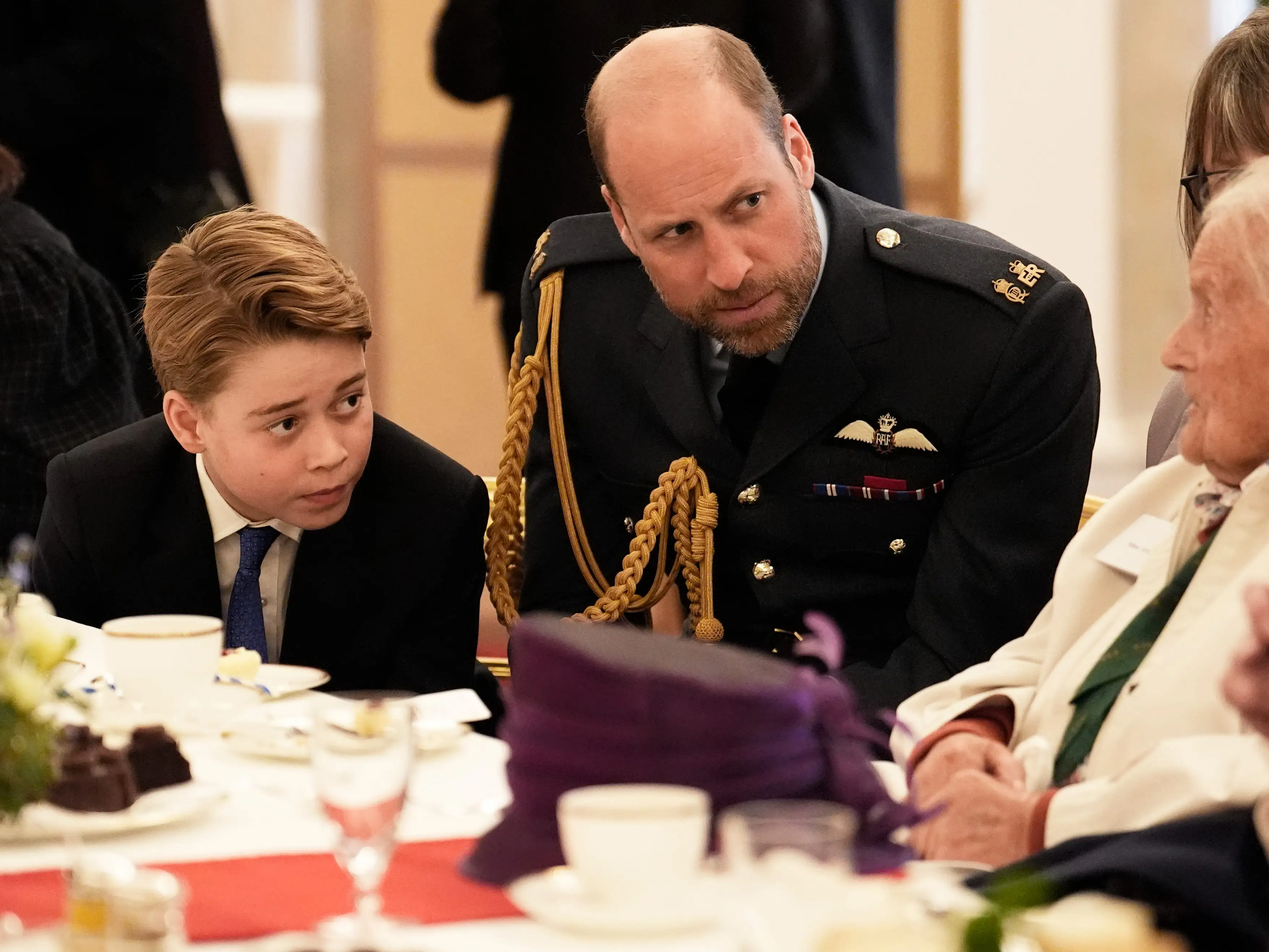 Prince William and Prince George join Second World War veterans at a tea party in Buckingham Palace in May 2025.