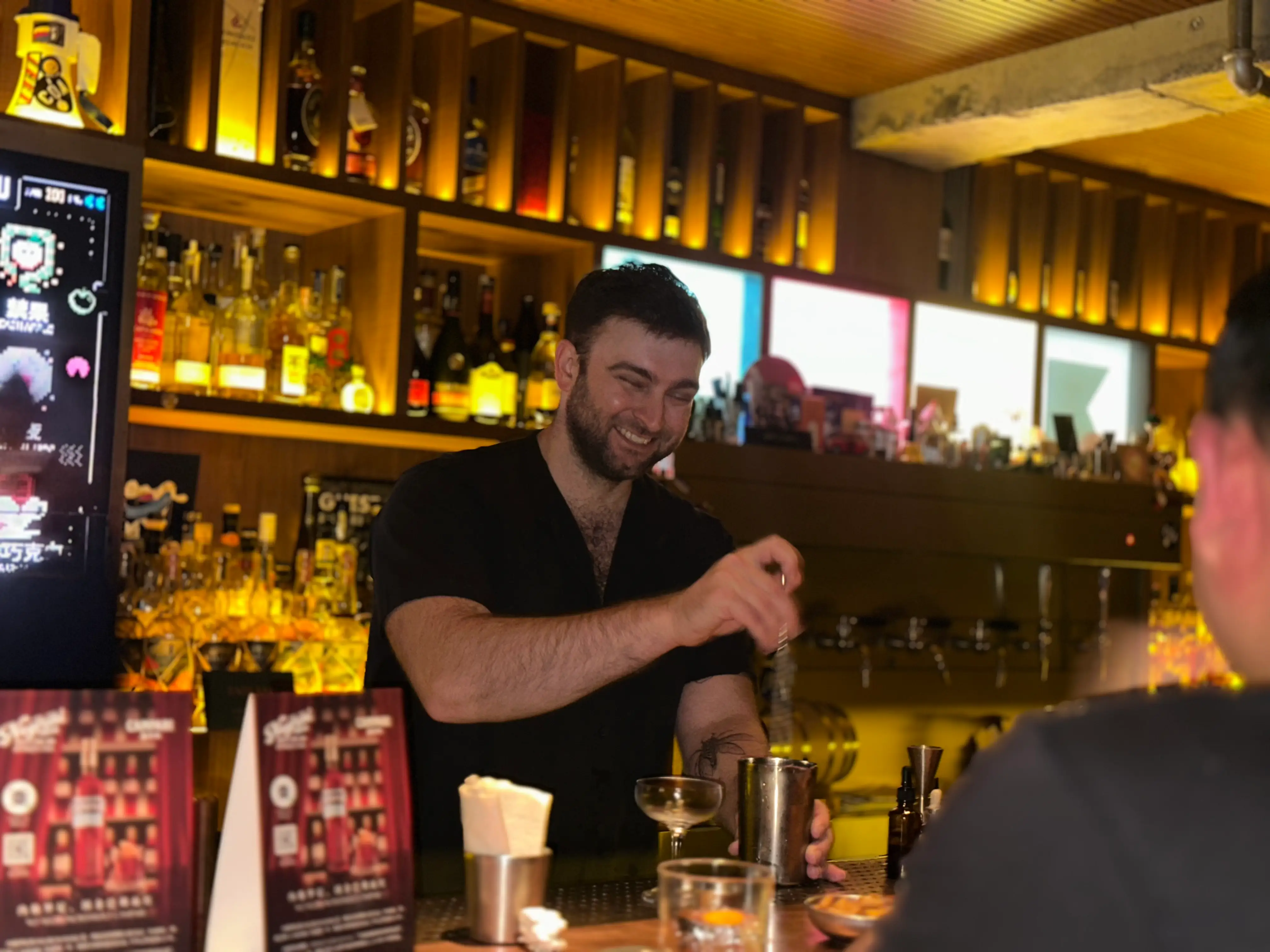 A man mixing a cocktail at a bar in China.