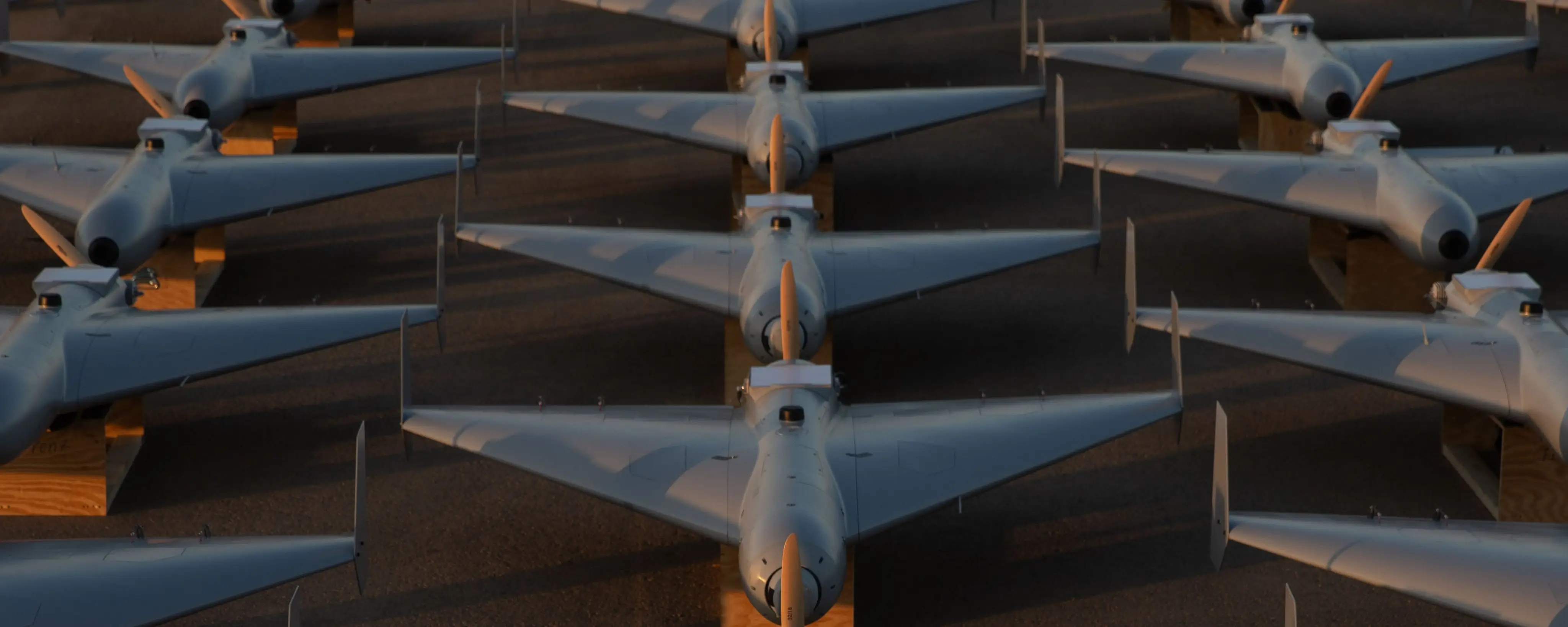 US drones sit on a tarmac.