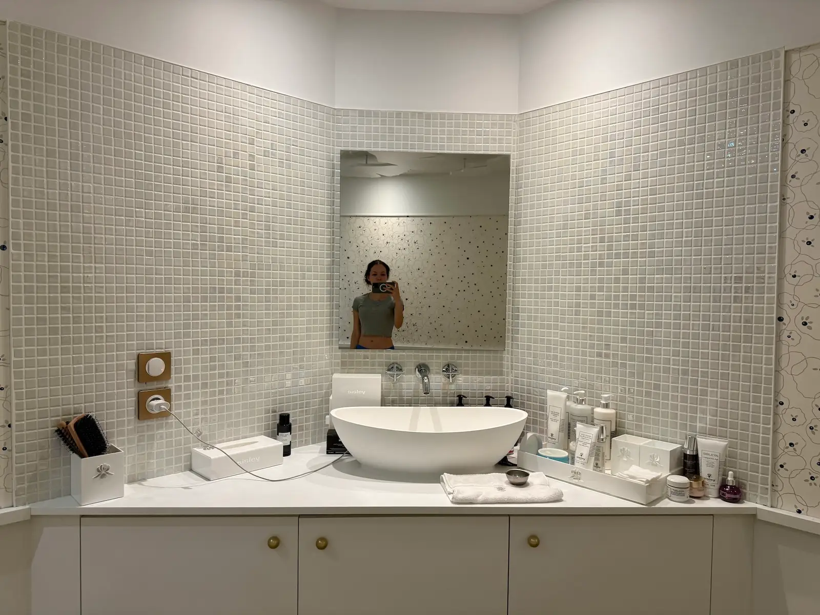 Woman taking selfie in Sisley Paris facial room