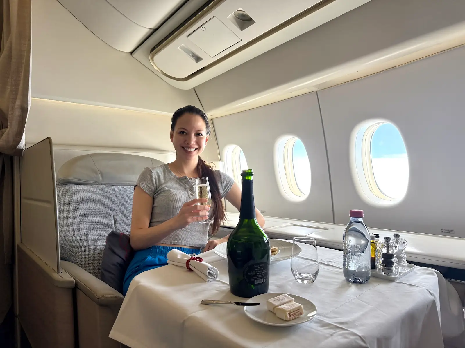 Woman in La Premiere First Class Air France drinking Laurent-Perrier Grand Siècle