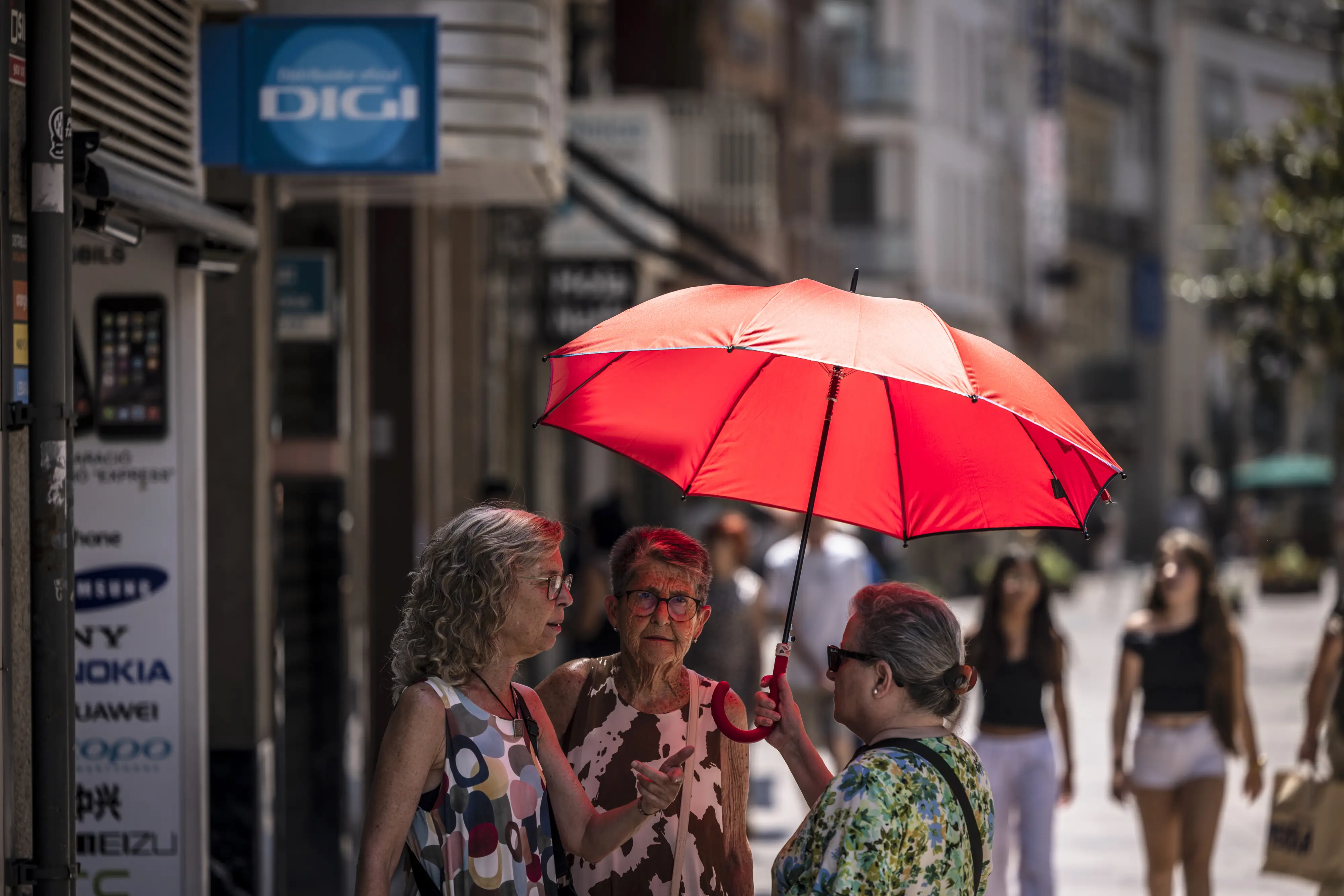 Residents sheltered from the sun beneath an umbrella during a heat wave in Lleida, Spain, on July 13, 2026.