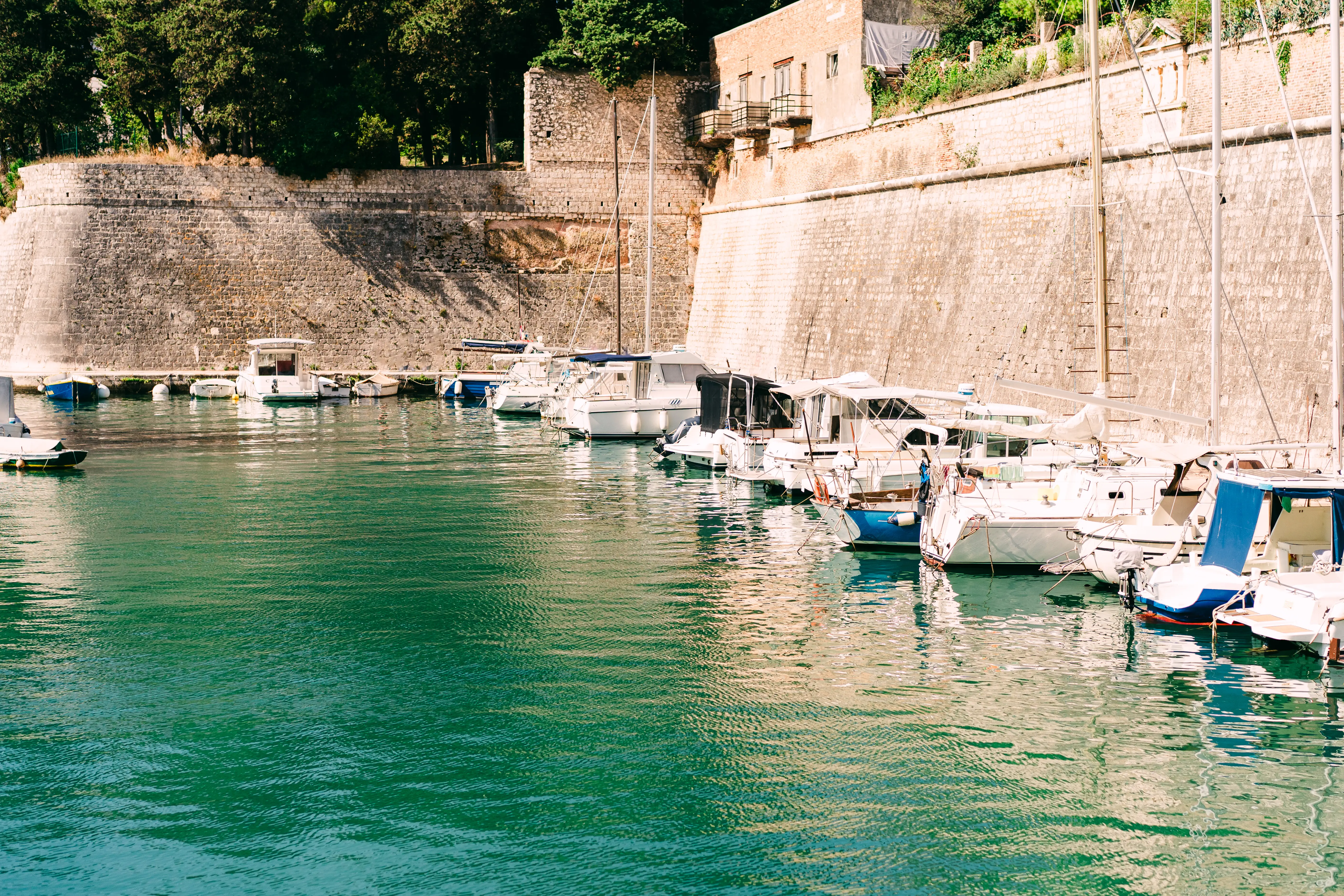 Boats docked near turquoise water in Zadar, Croatia.