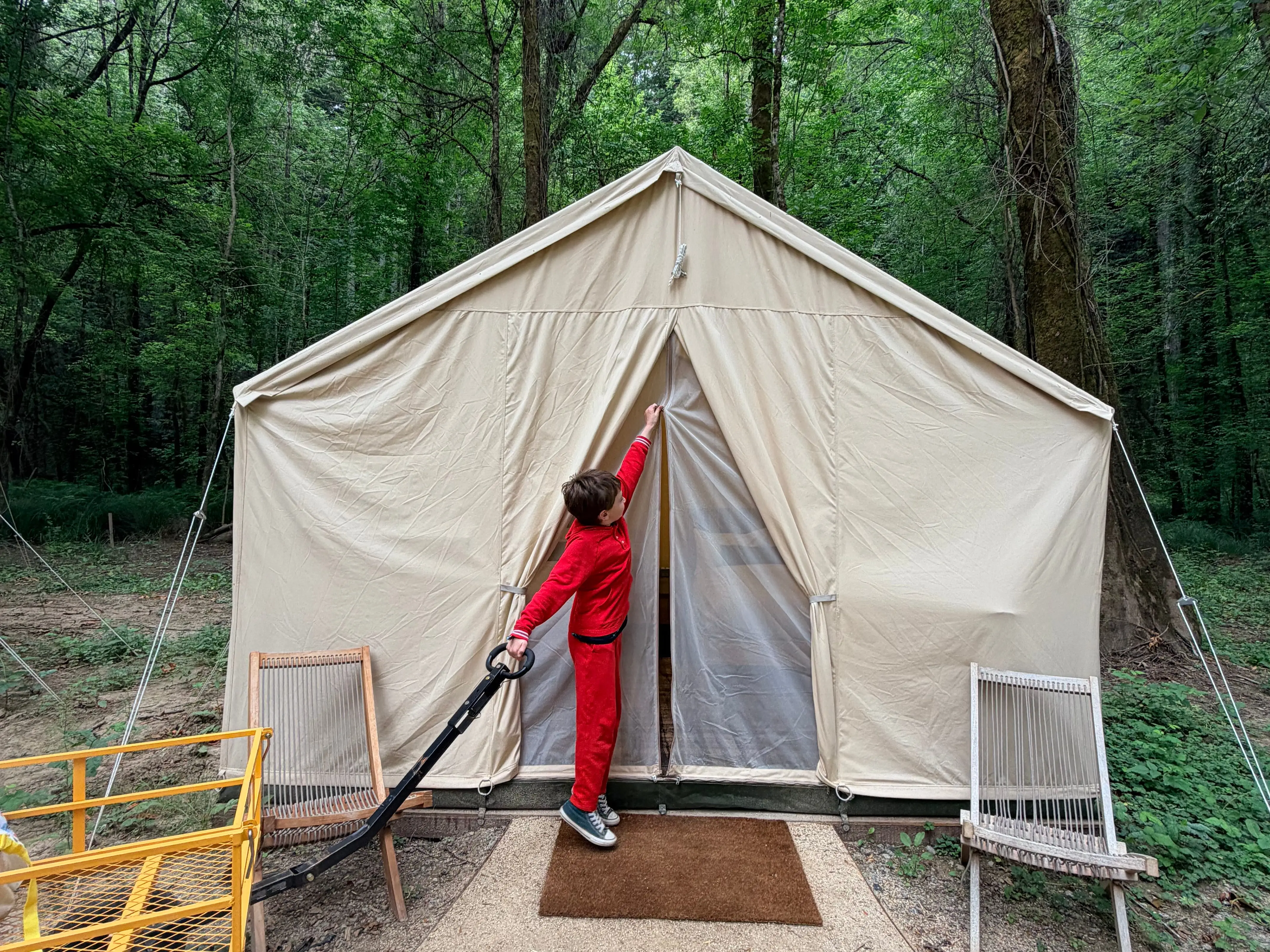The author's son opening their tent.