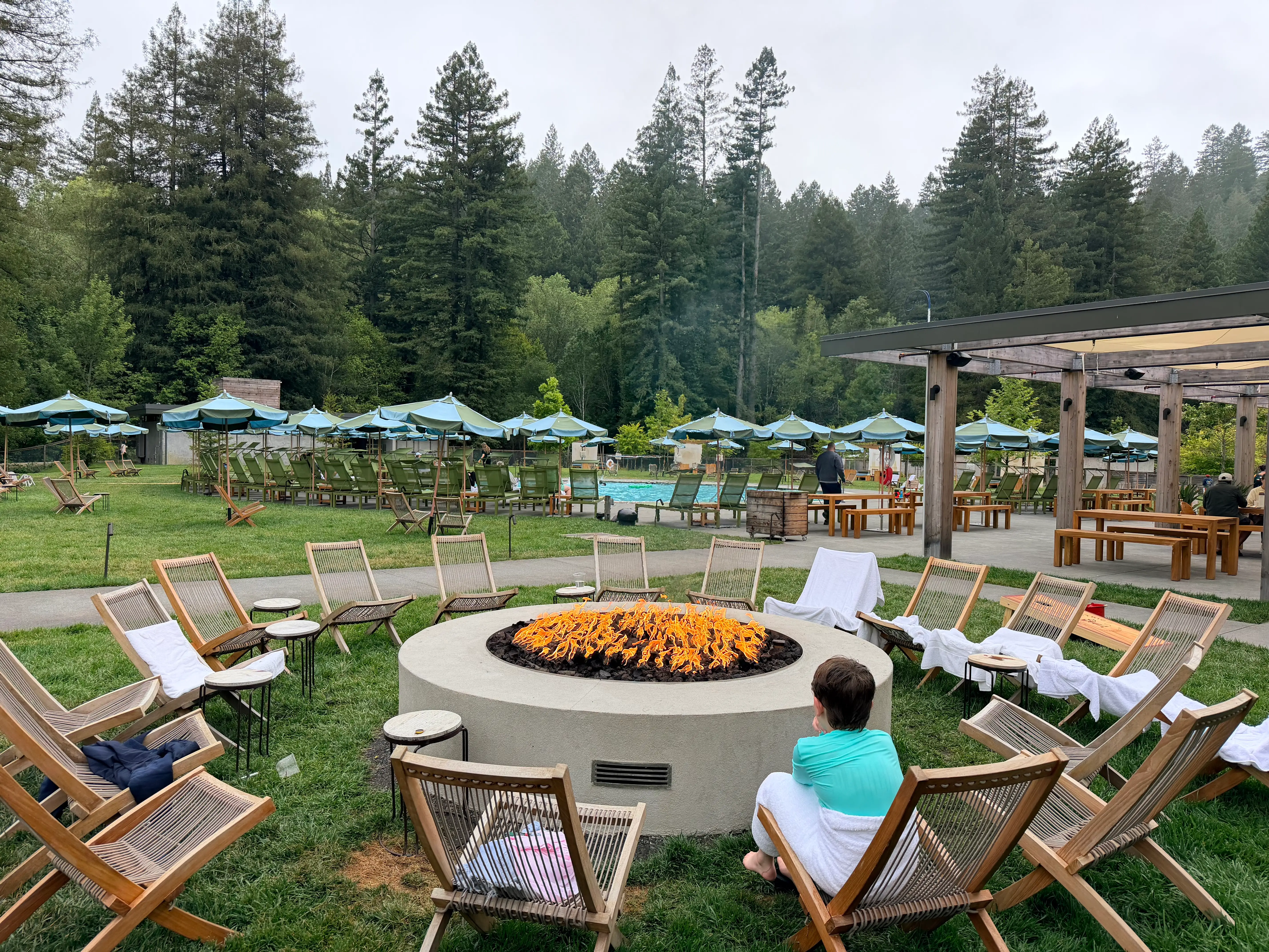 The author's son sitting by the outdoor fire pit.