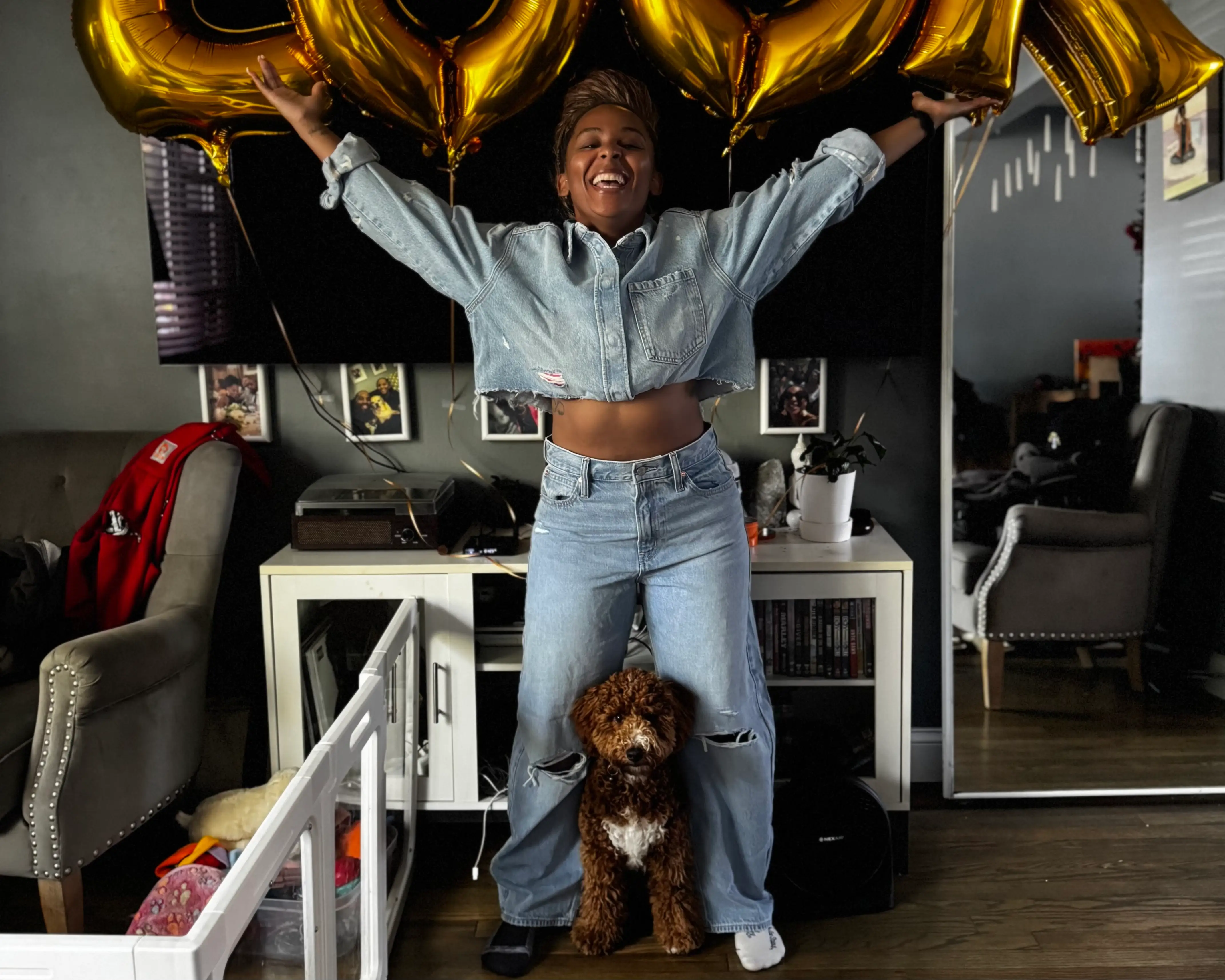 Woman smilingwith dog, balloons above her h