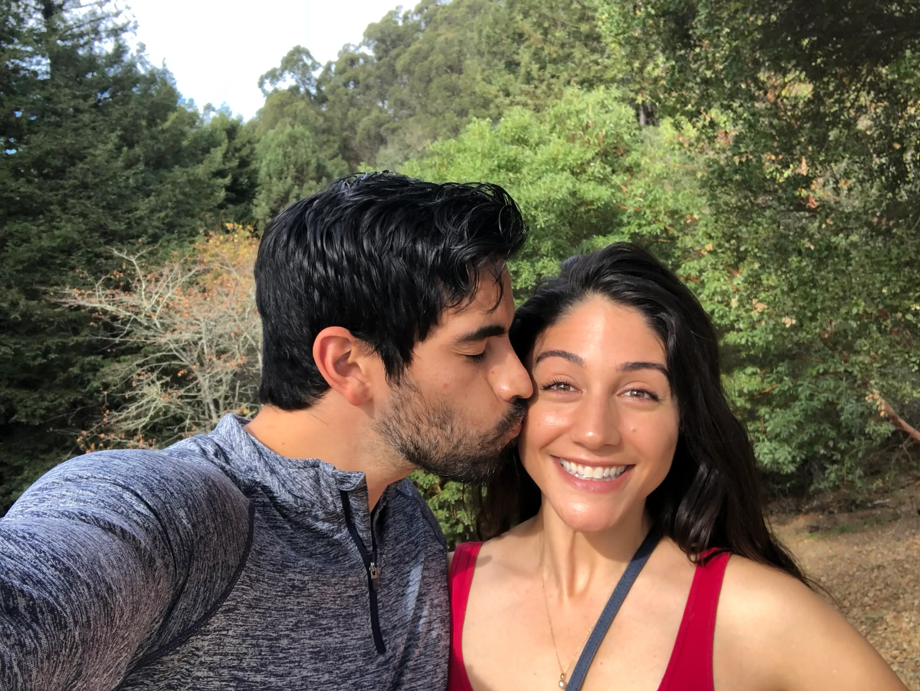 The author gets a kiss from her husband while on a path outside.