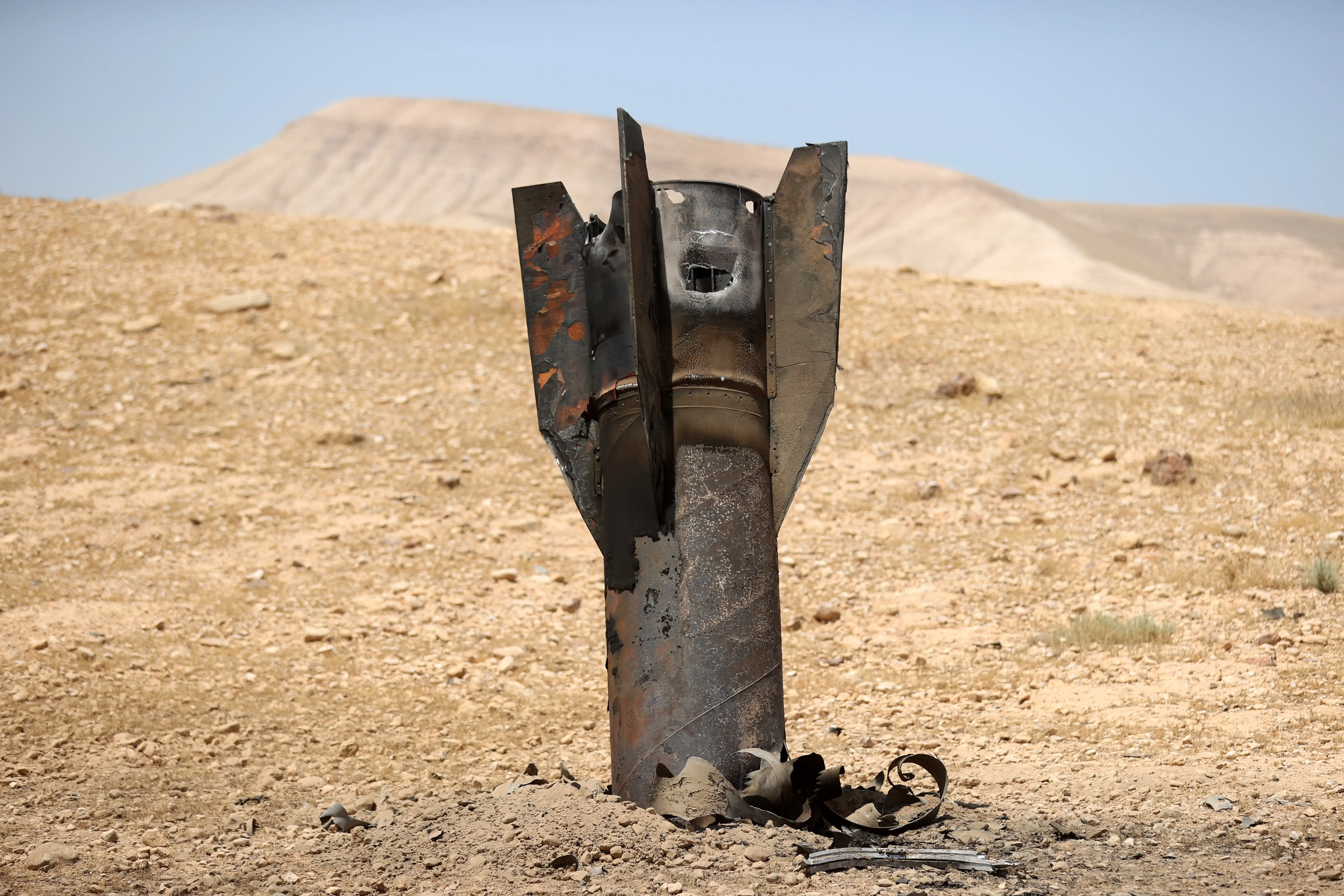 A fragment of an Iranian ballistic missile intercepted by Israeli air defense systems is seen after falling in an area near the city of Jericho in the eastern West Bank.