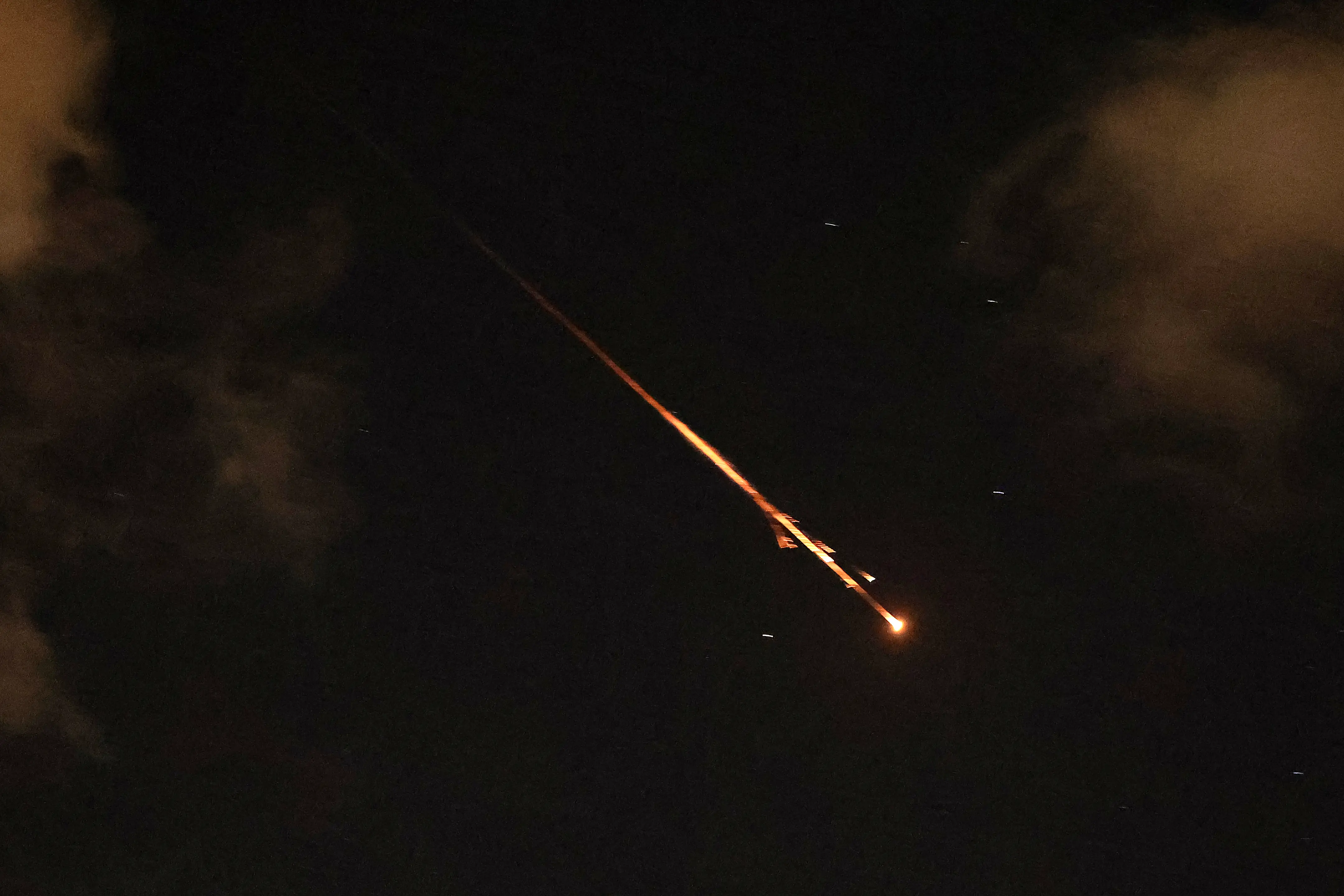 Rocket trails are seen in the sky above Netanya, Israel, on April 8, 2026.
