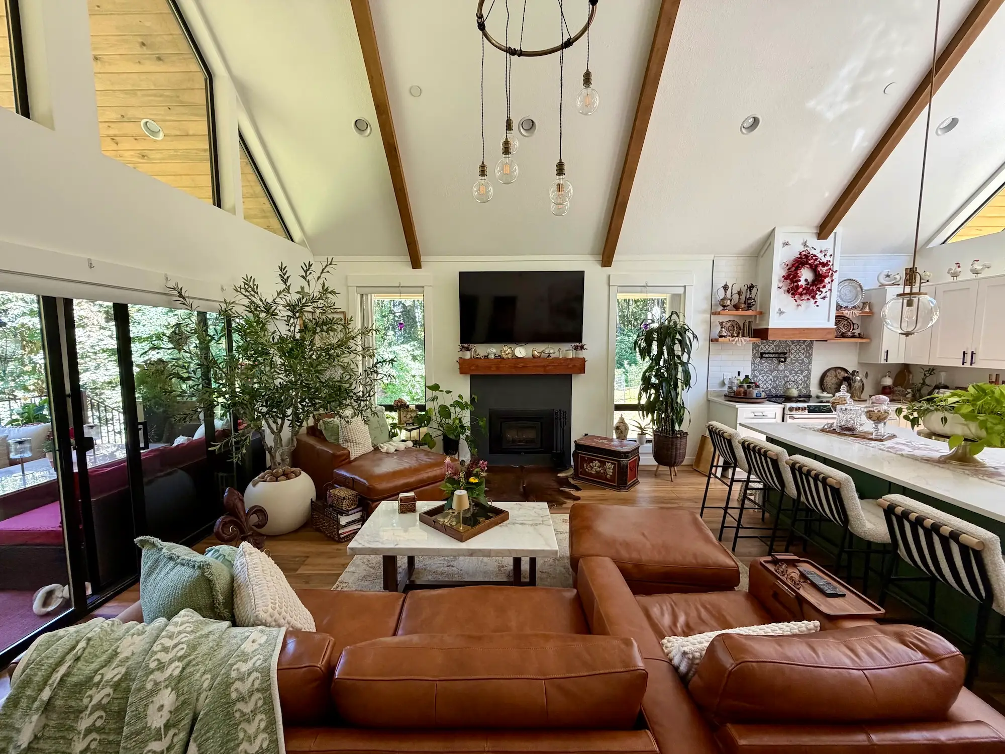 A living area next to a large island. A fireplace sits on the far wall.