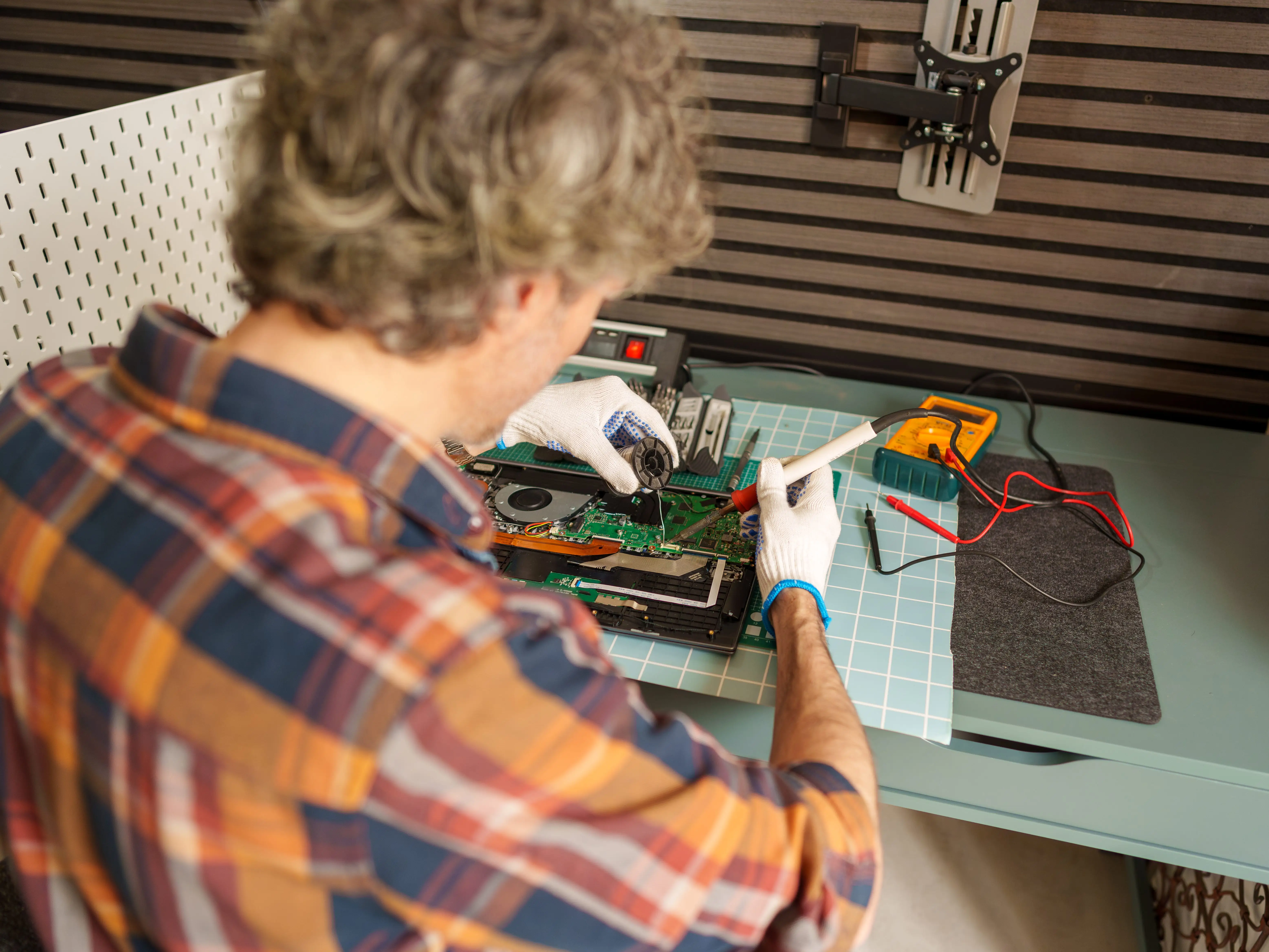 a man welding and soldering electronics
