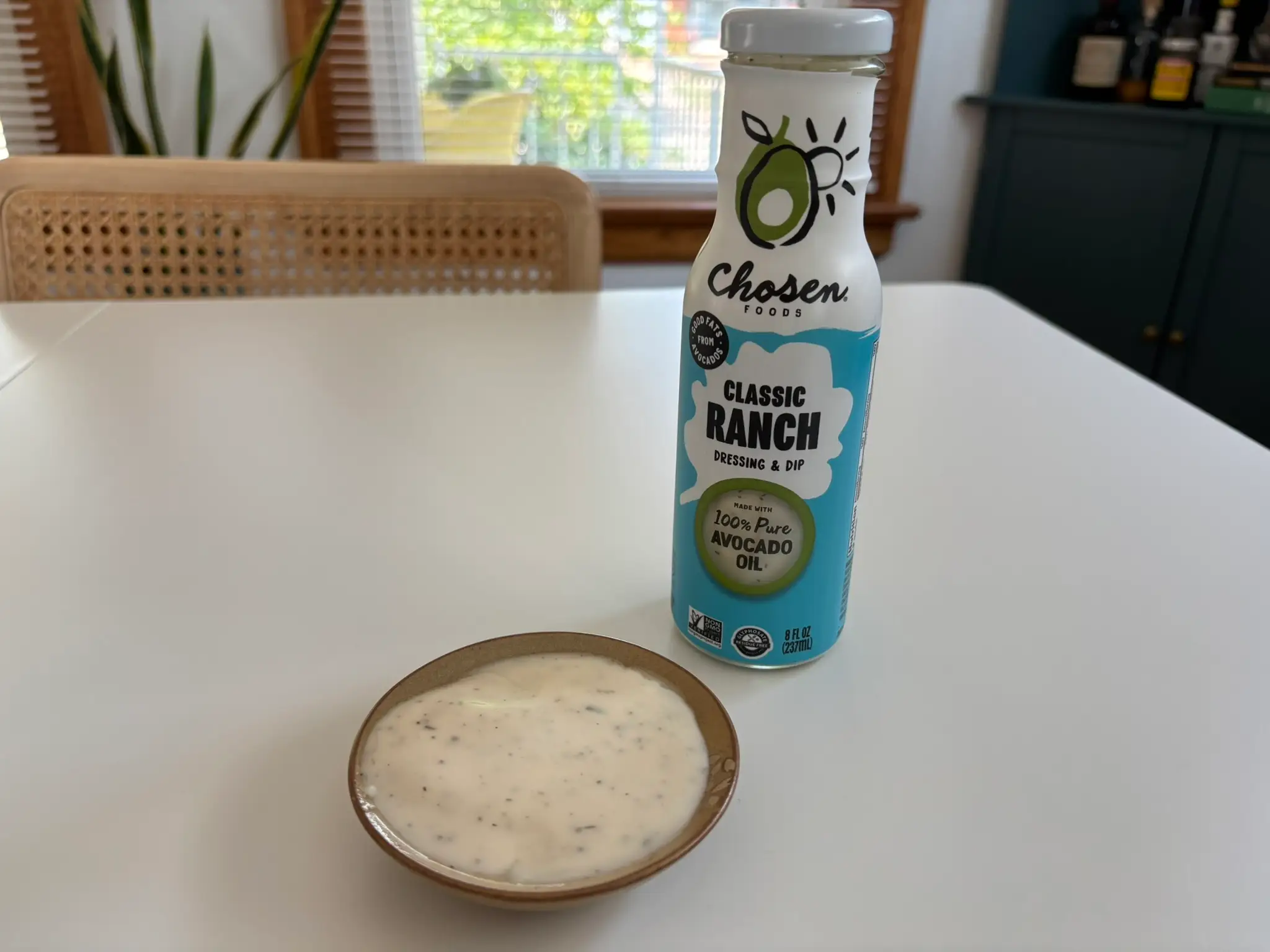 Chosen Foods ranch dressing bottle with small bowl of ranch next to it