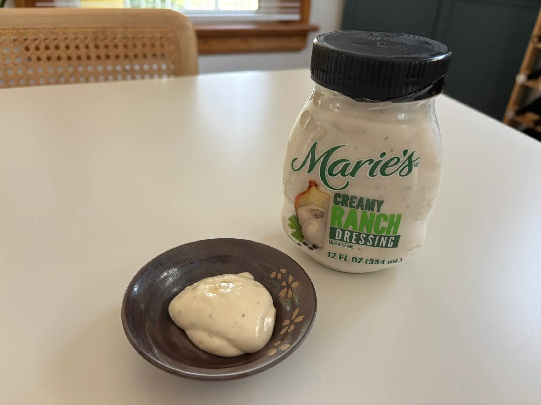 Marie's  ranch dressing bottle with small bowl of ranch next to it