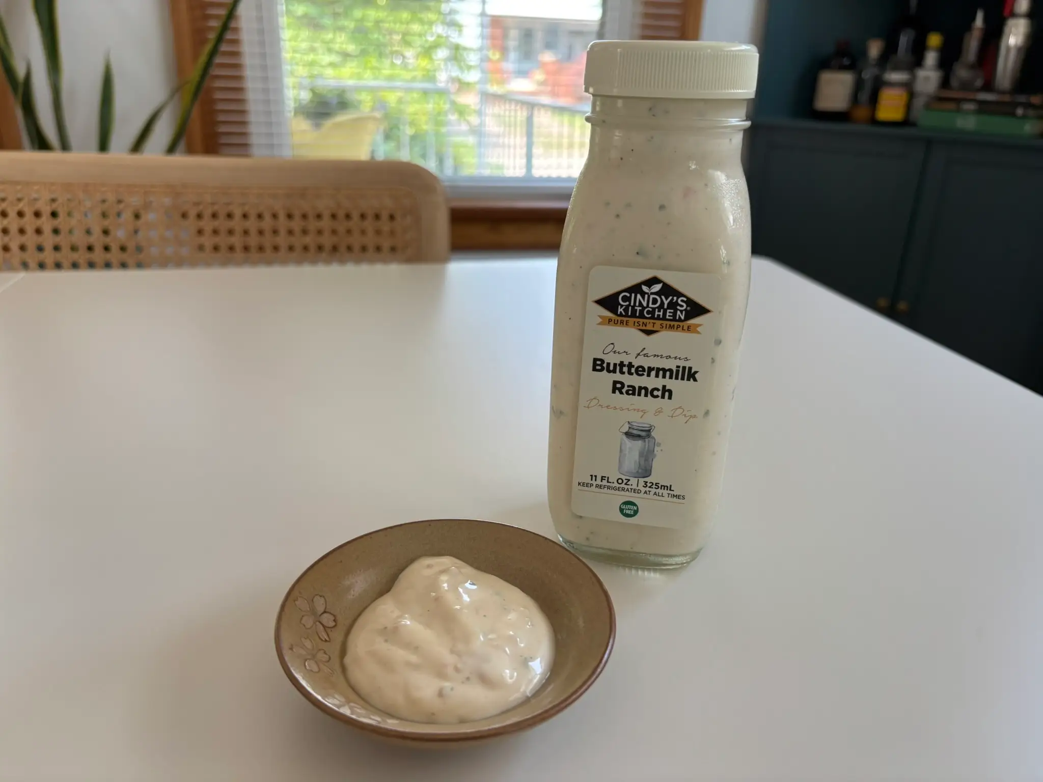 Cindy's  ranch dressing bottle with small bowl of ranch next to it