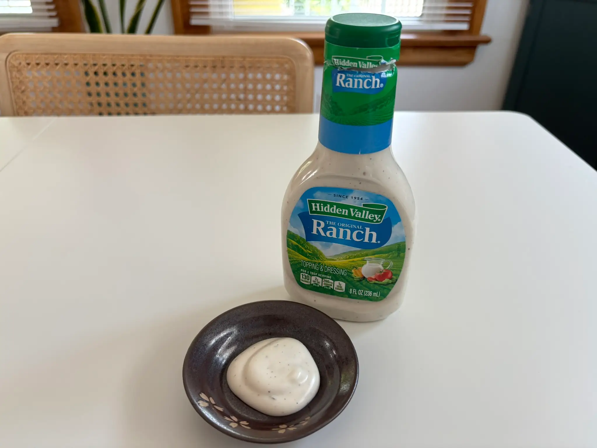Hidden Valley  ranch dressing bottle with small bowl of ranch next to it