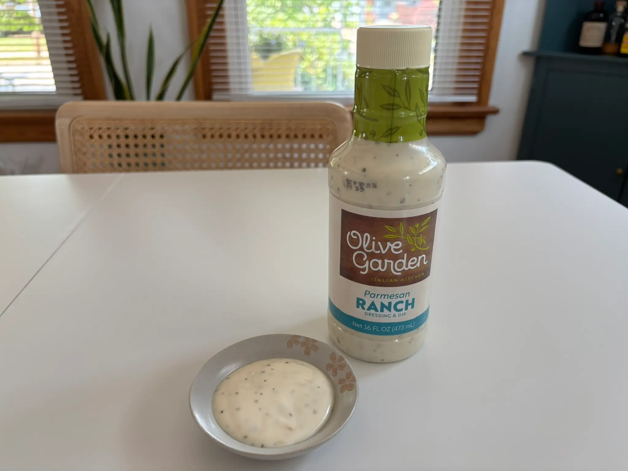 Olive Garden  ranch dressing bottle with small bowl of ranch next to it