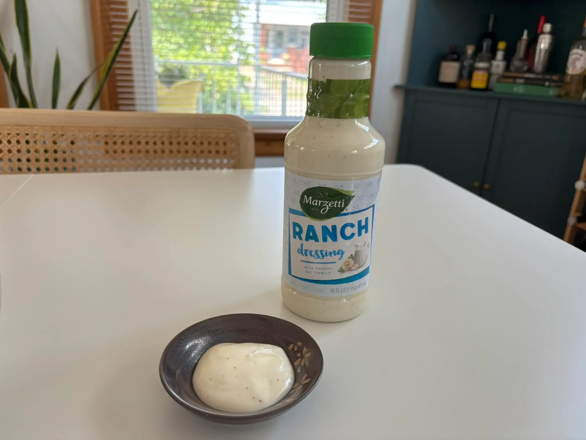 Marzetti  ranch dressing bottle with small bowl of ranch next to it