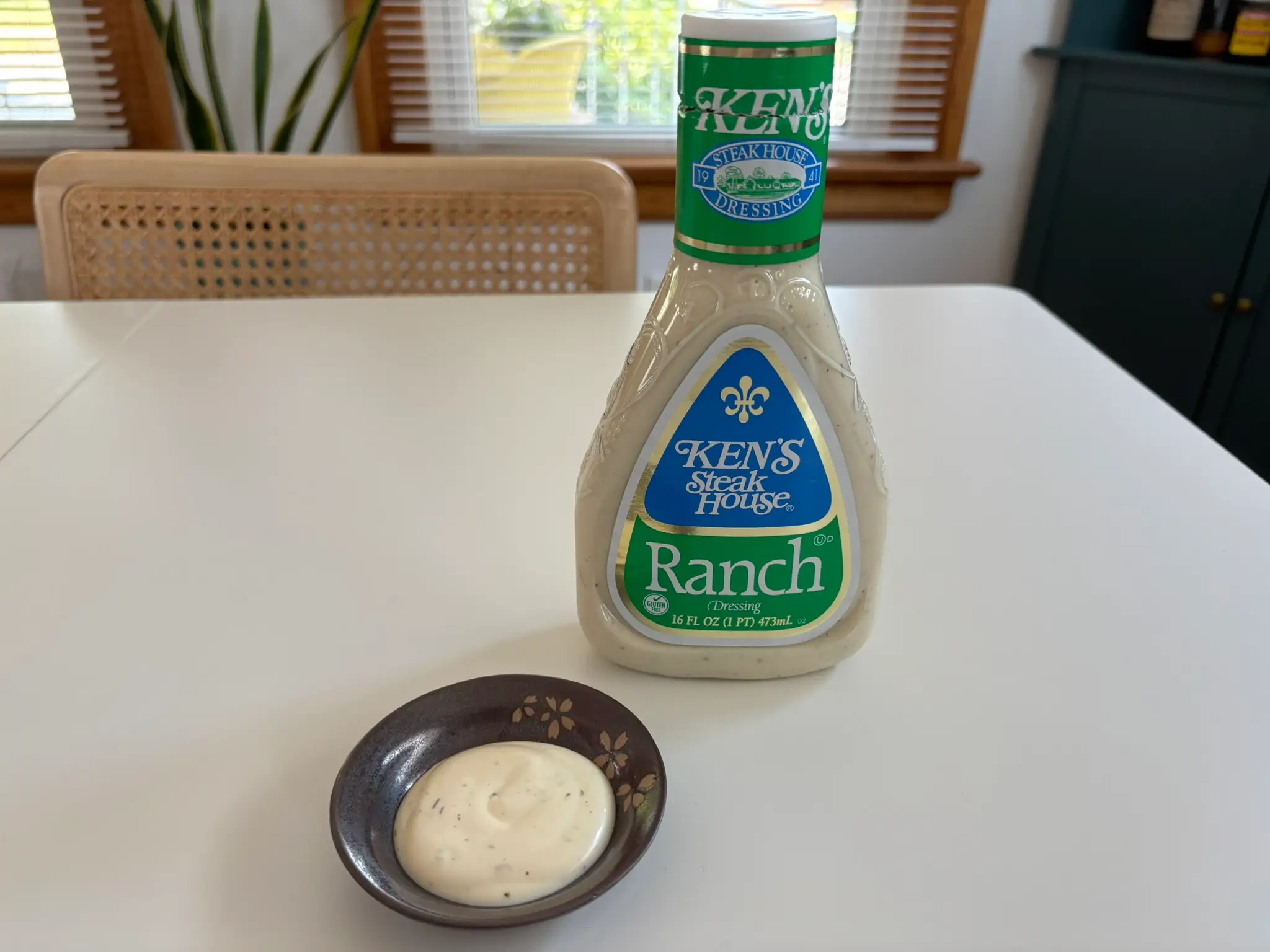 Ken's  ranch dressing bottle with small bowl of ranch next to it