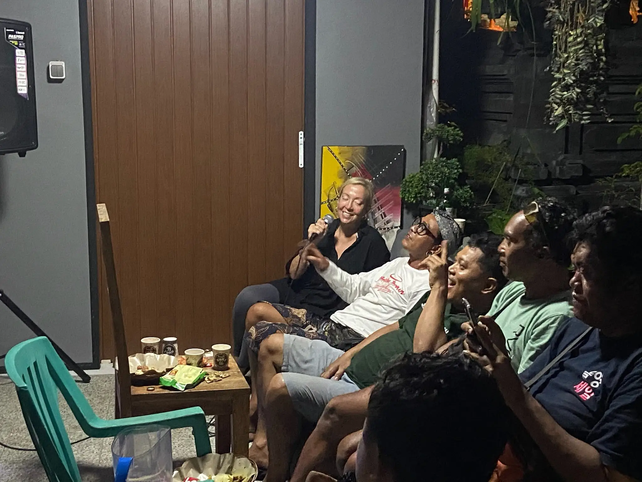 A group of people singing karaoke in Bali.