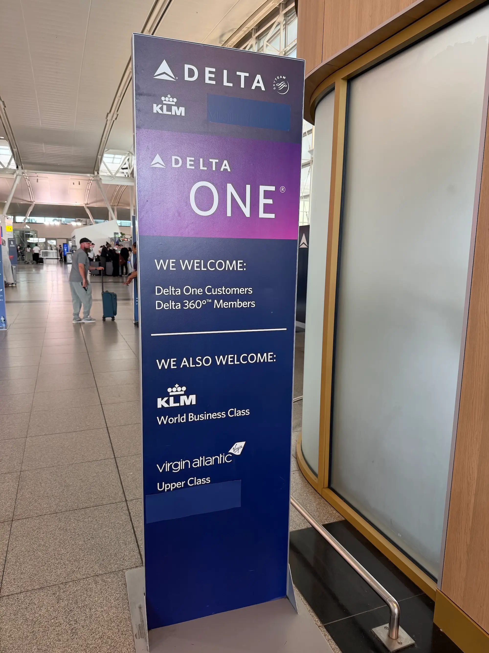 Delta One welcome sign for Delta, KLM and virgin atlantic premium customers in an airport terminal.
