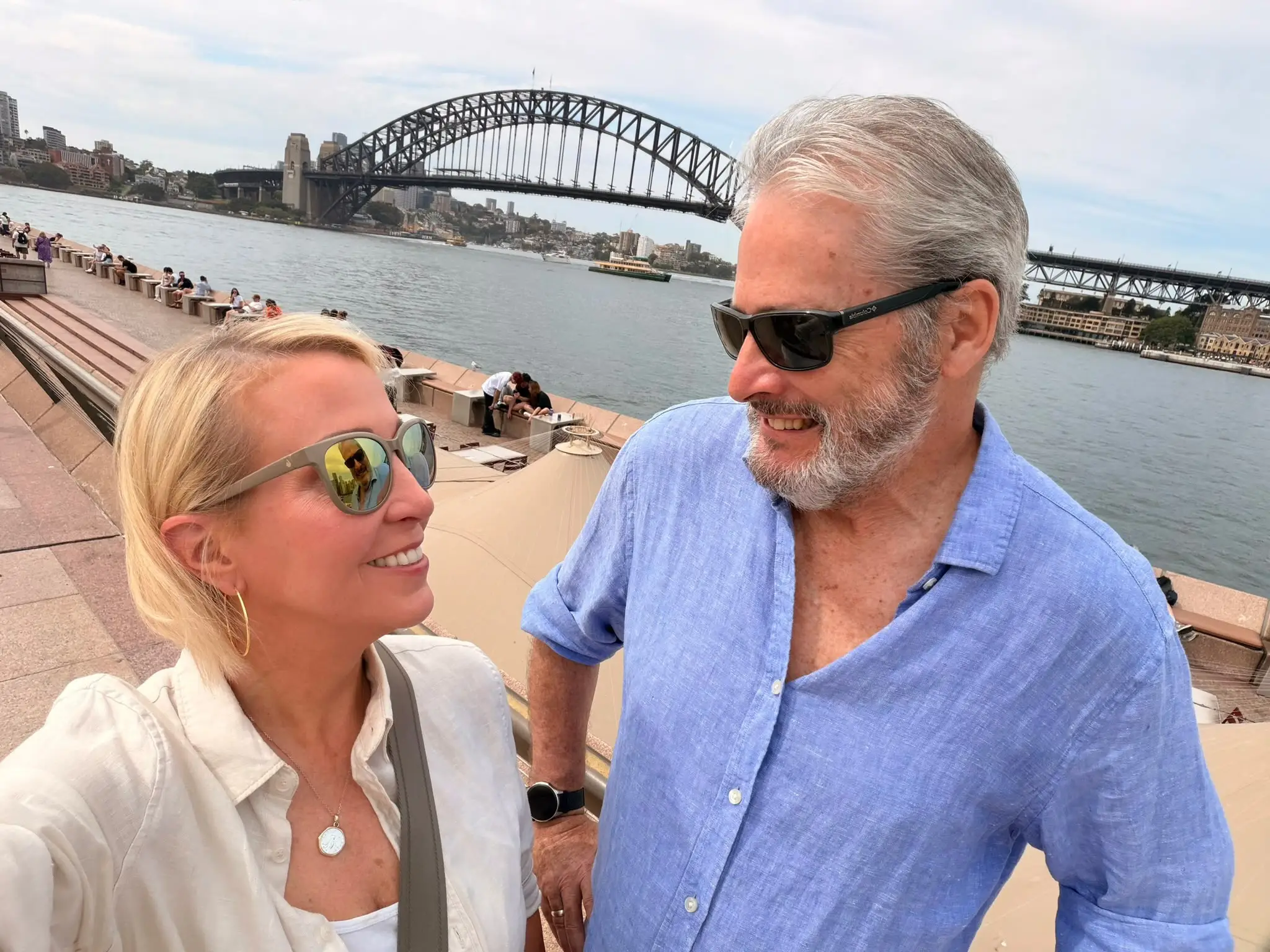 A couple posing by the bridge in Sydney.