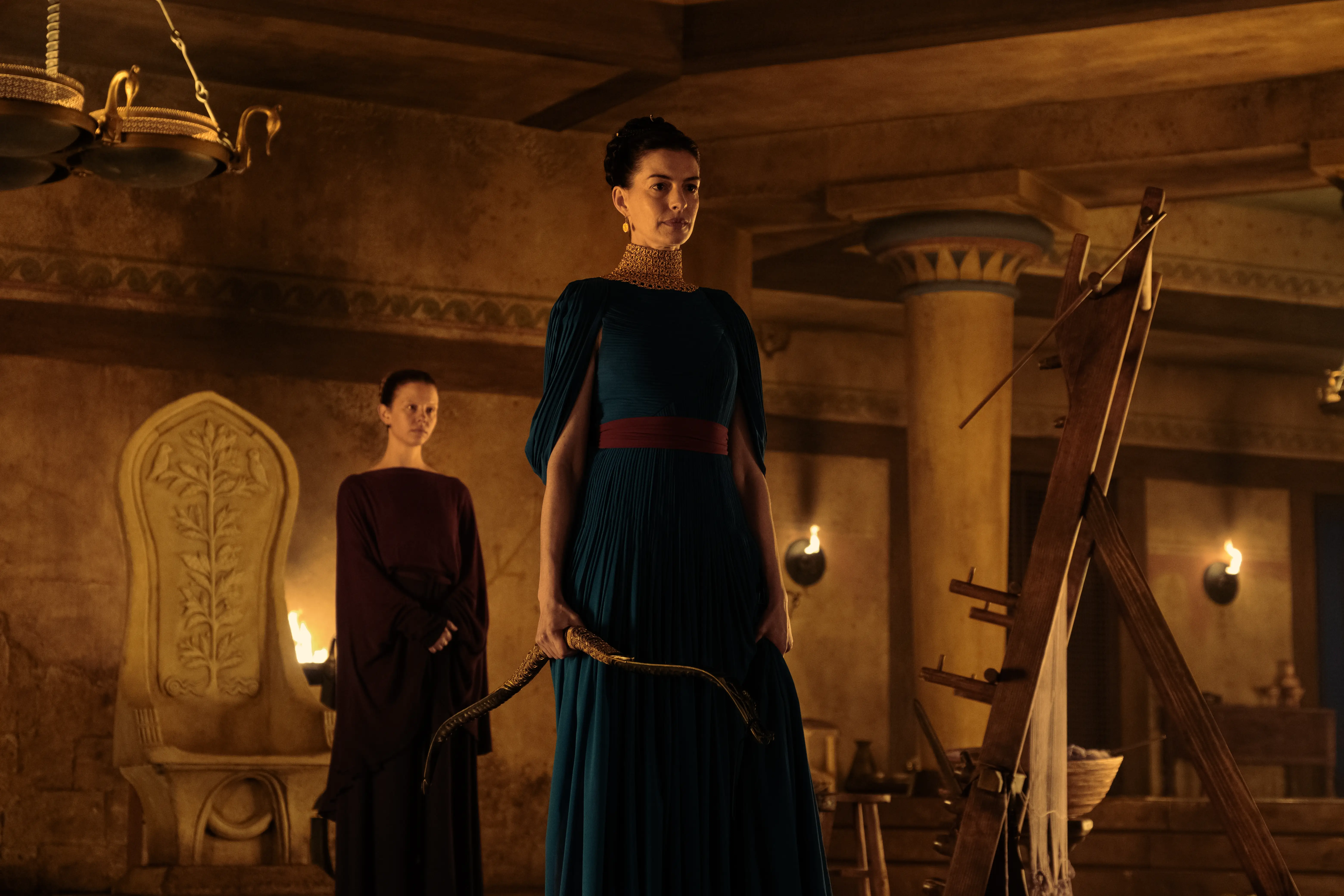 Mia Goth as Melantho and Anne Hathaway as Penelope in Christopher Nolan's movie 