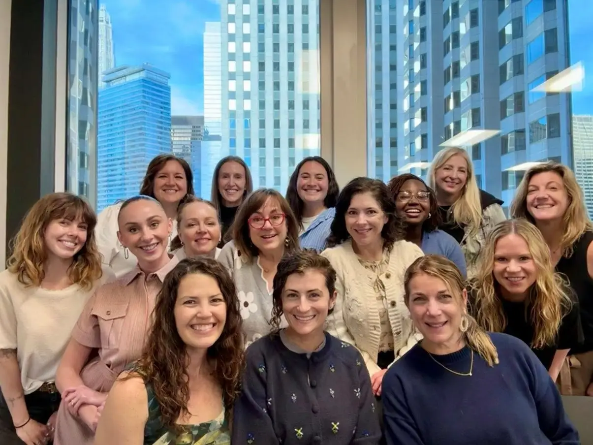 Members of an all-female poker group pose for a photo together.