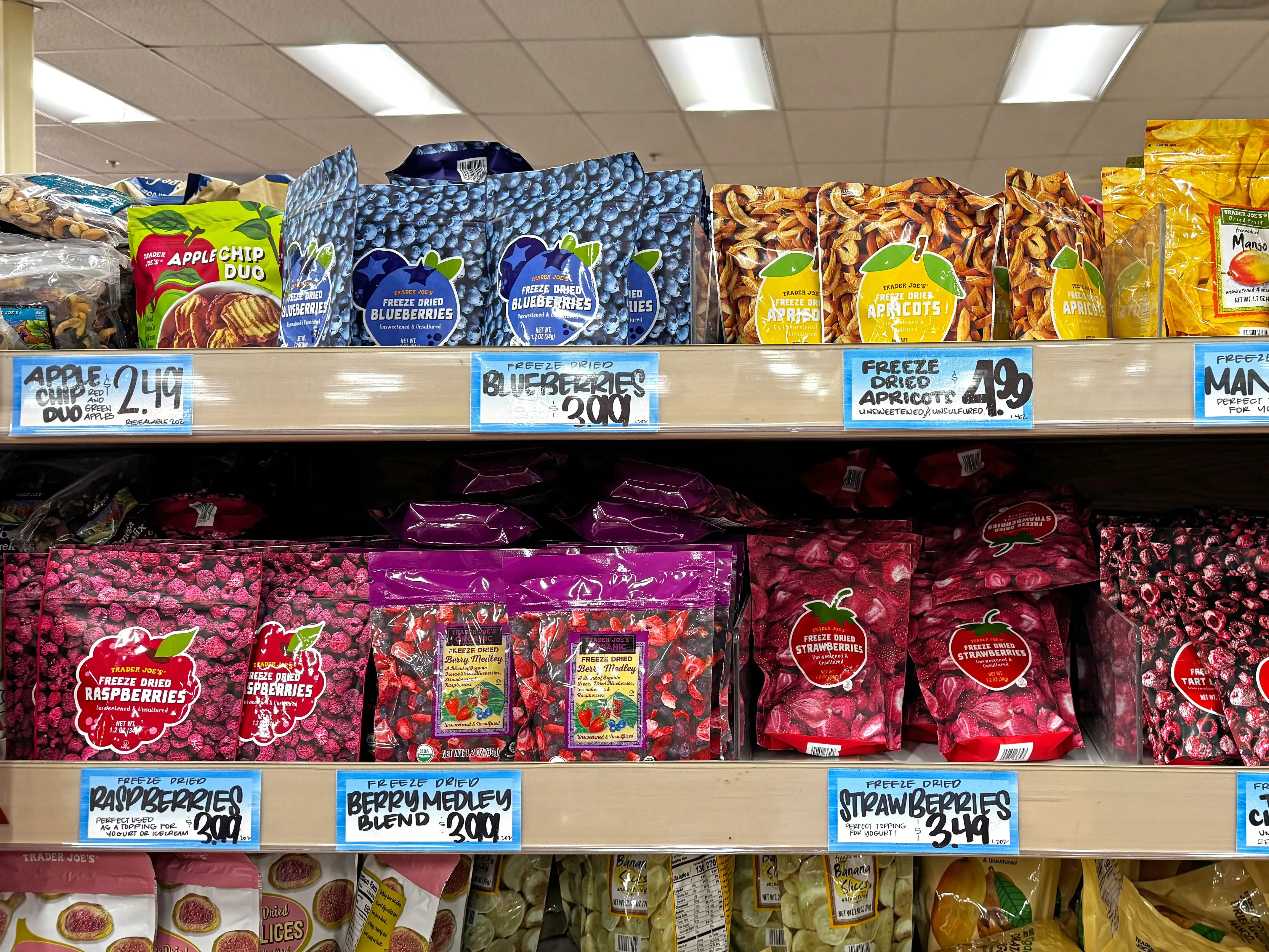 Assorted bags of dried fruit on shelves at Trader Joe's.