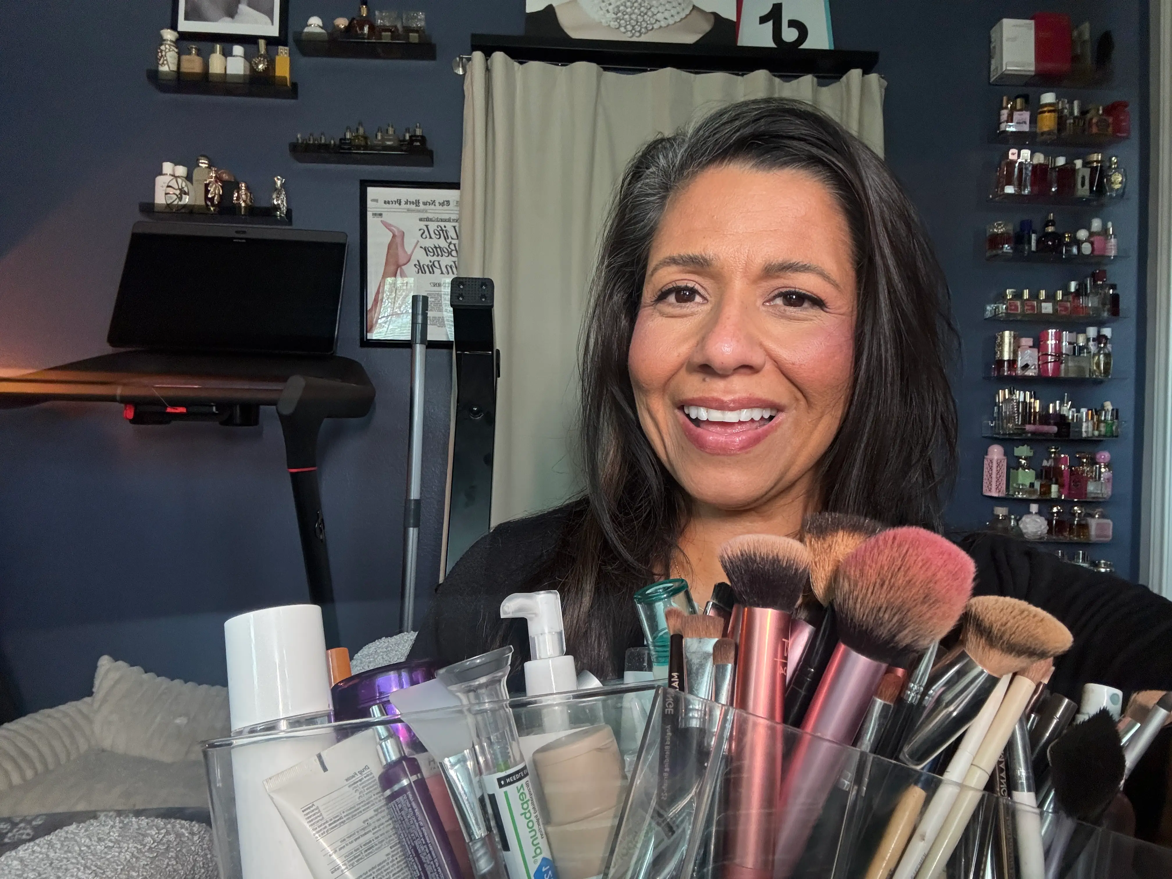 Author Suzie Jimenez smiling with bin of makeup and skincare products