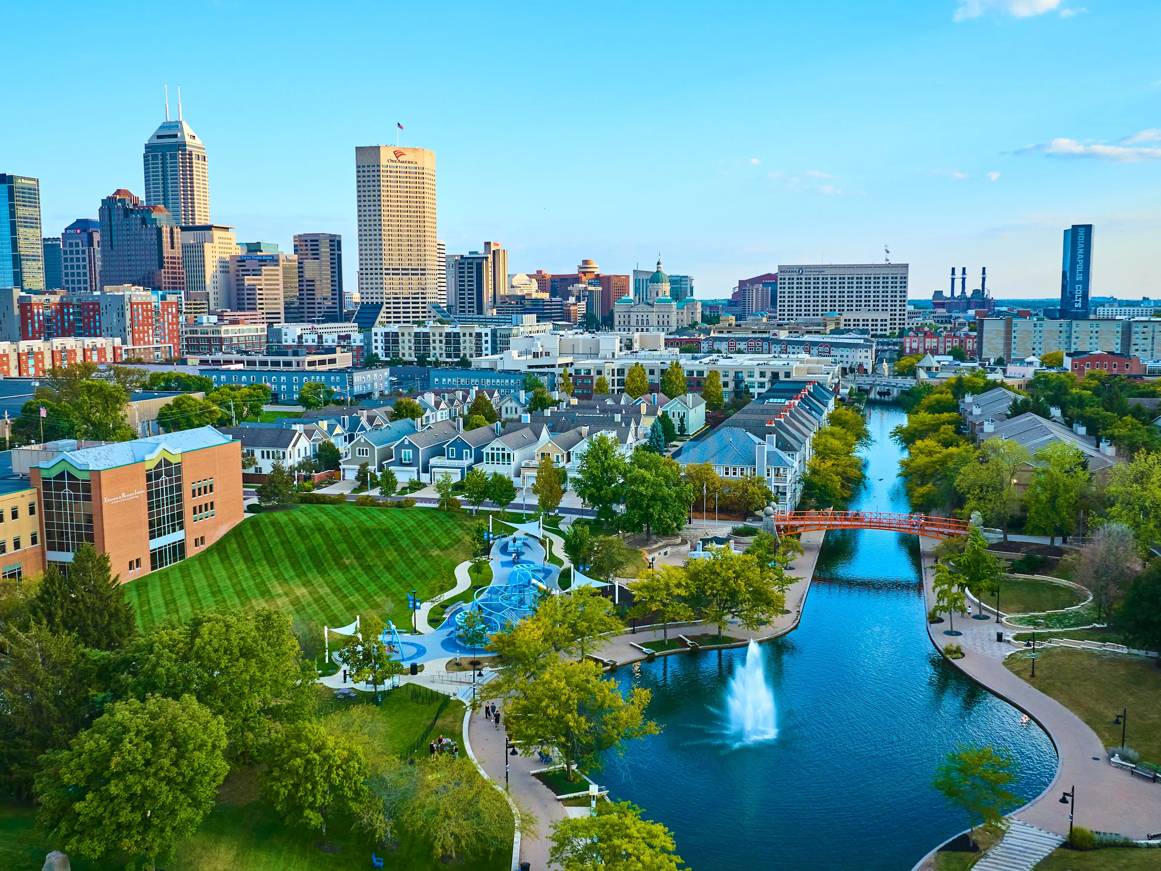 Aerial View of Vibrant Indianapolis Cityscape with Serene Park and Waterway at Golden Hour