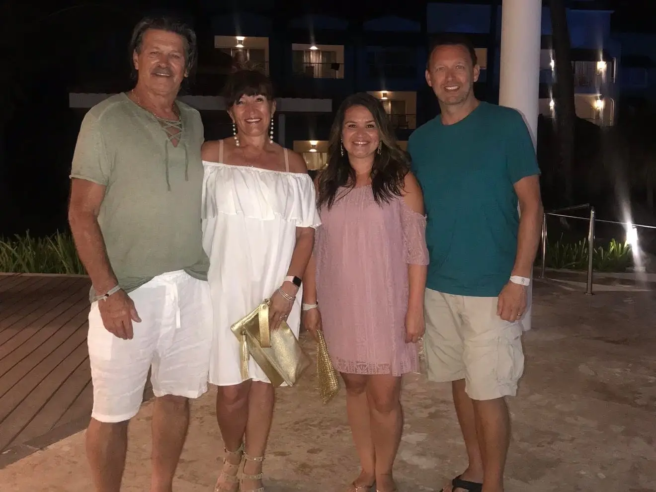 Four people pose together for a photo.