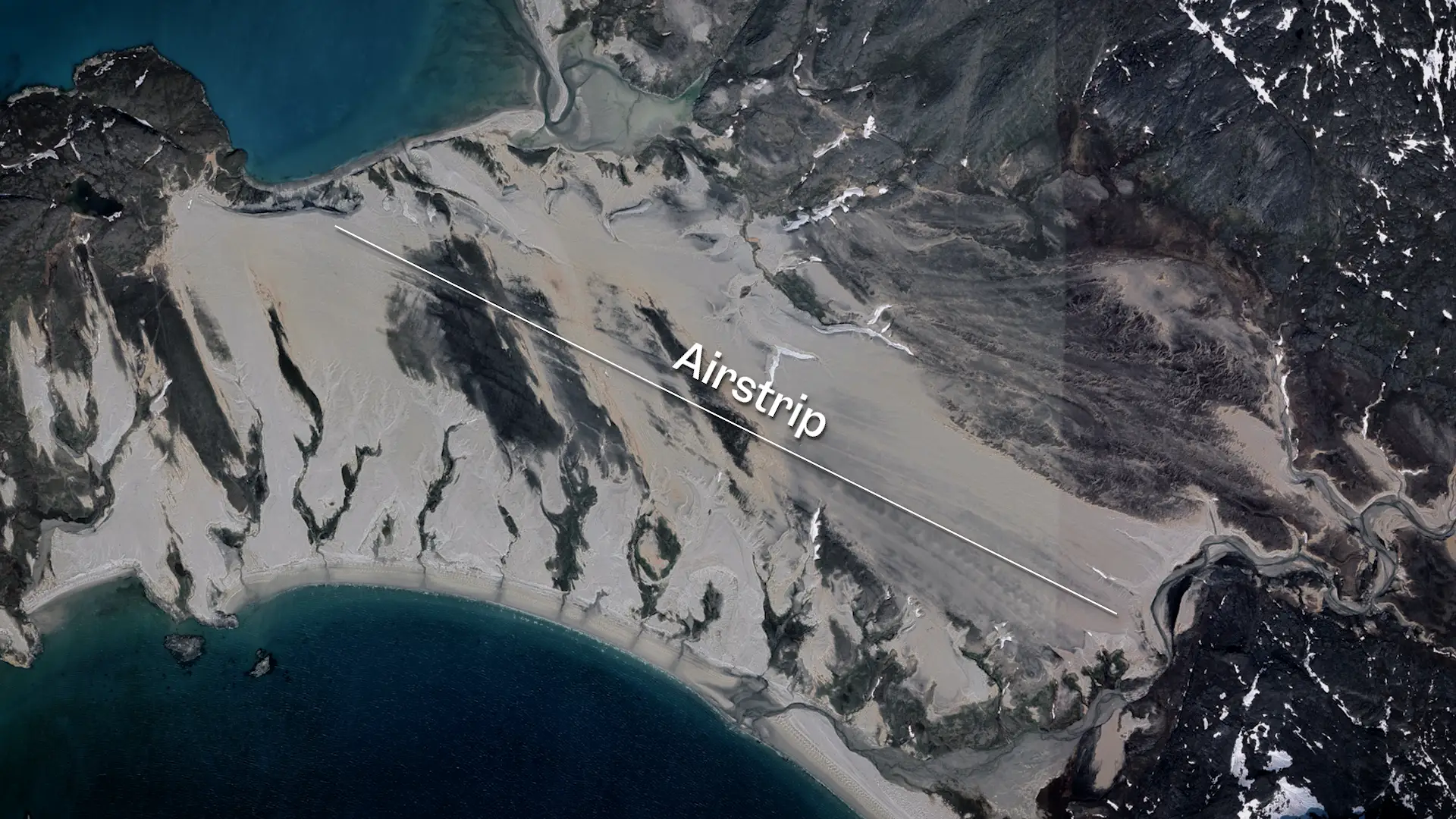 A satellite image of a desolate beach with a line labelled