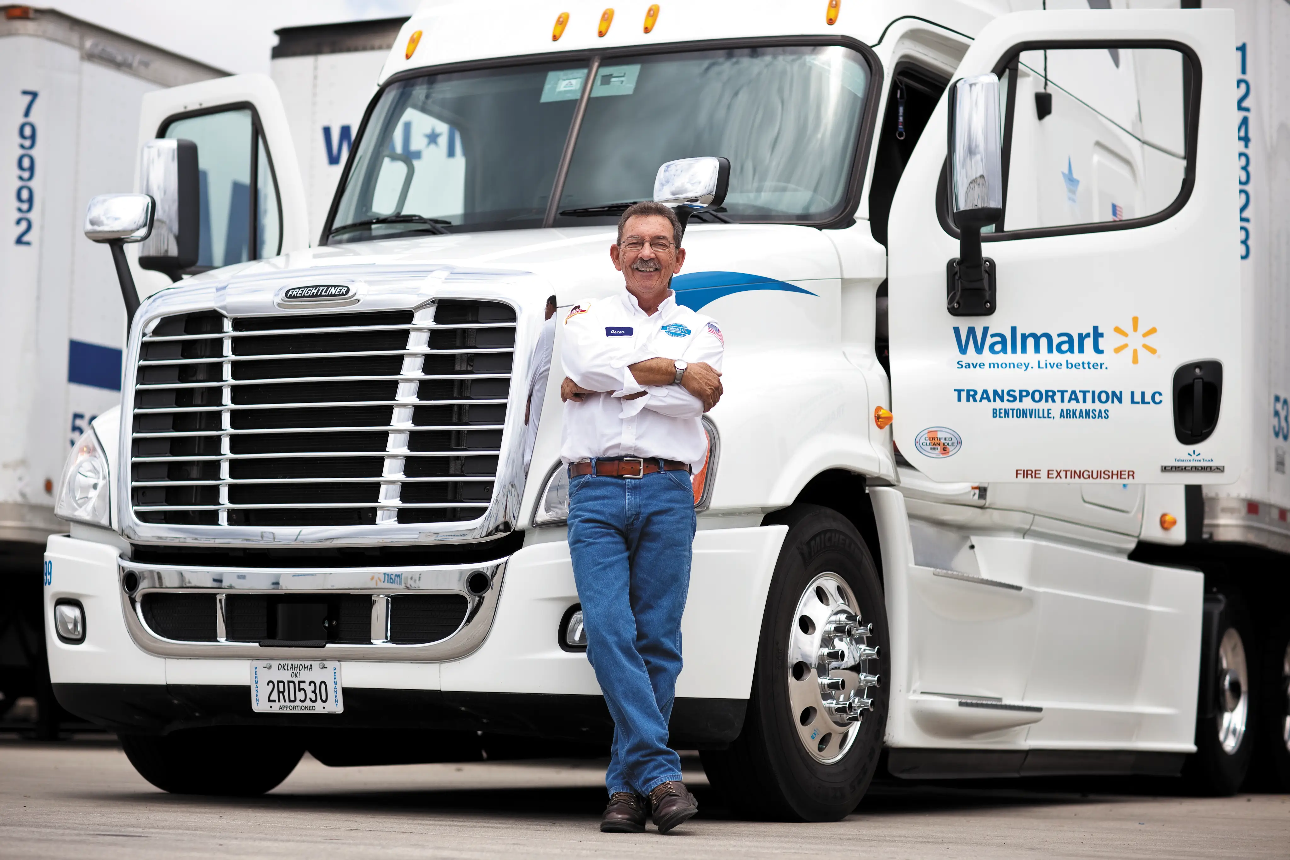 A Walmart driver in front of a truck.