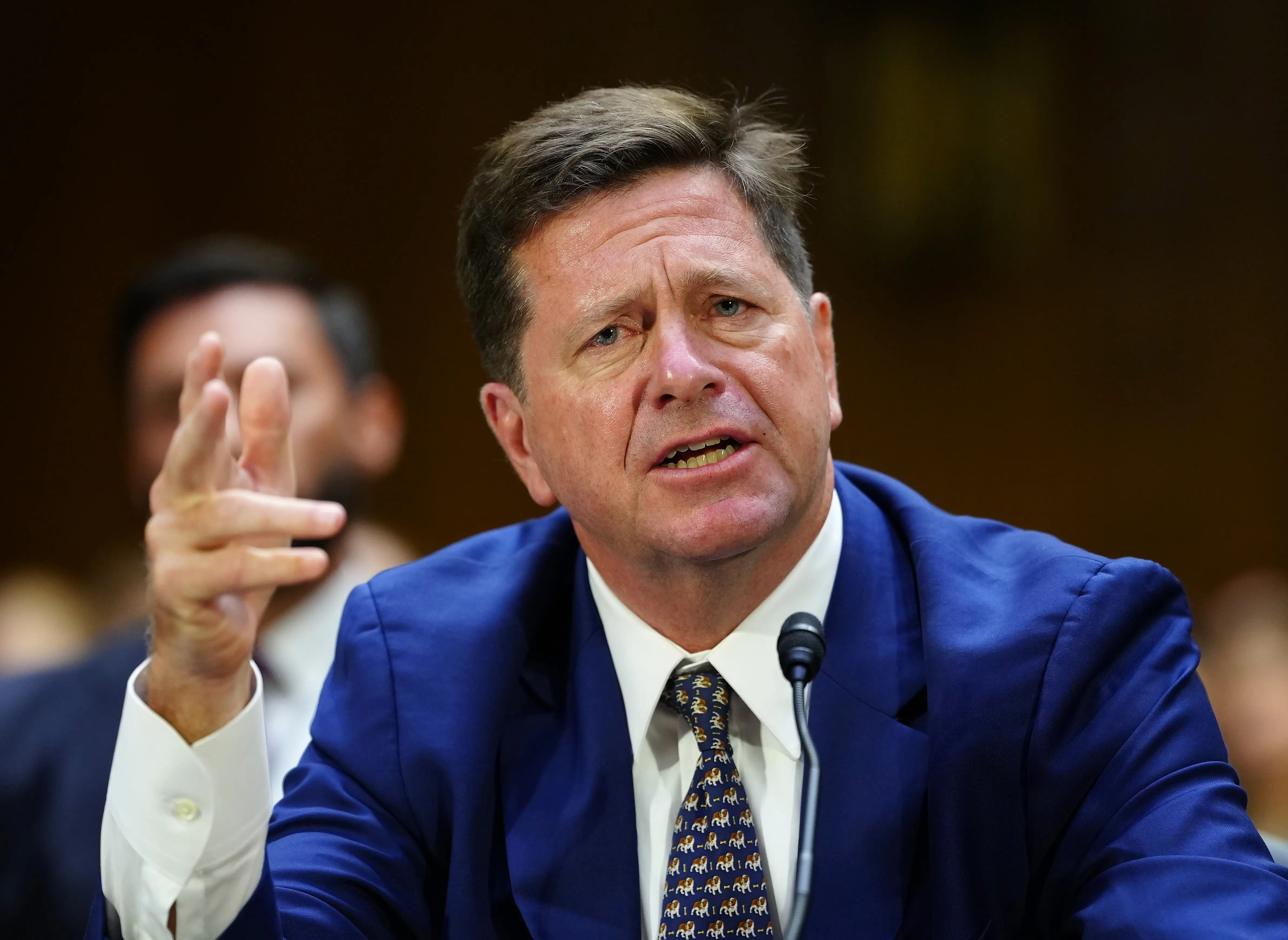 Jay Clayton seated with his hand cocked
