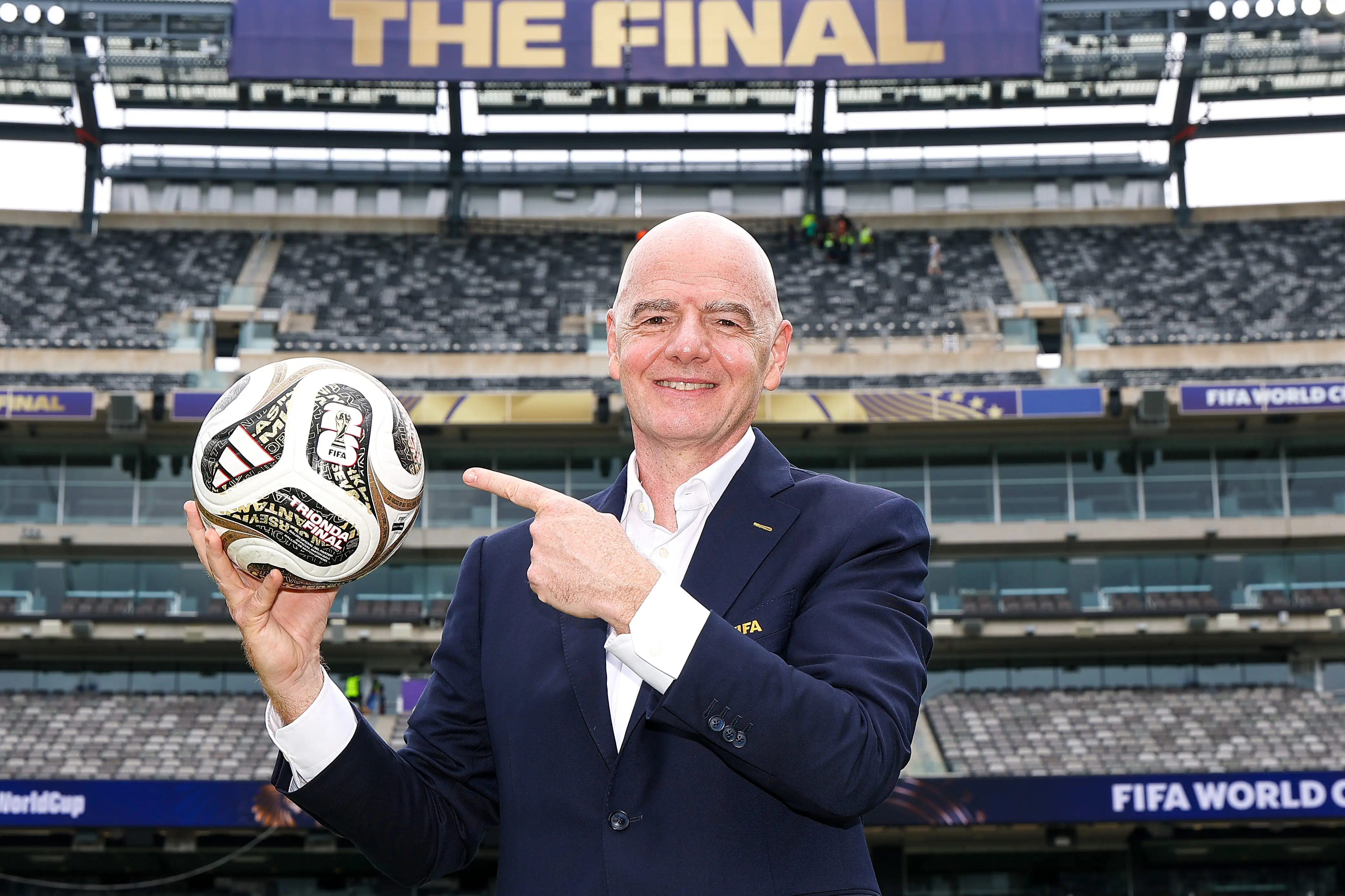 FIFA President Gianni Infantino poses with the TRIONDA FINAL the Official Match Ball for the semi-finals, bronze final and final during his visit to the New York New Jersey Stadium on July 09, 2026 in East Rutherford, New Jersey.