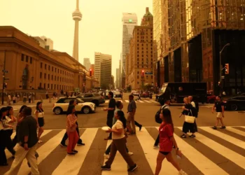 Canadian wildfires are shrouding US cities in smoke and yellow haze. See the eerie photos.